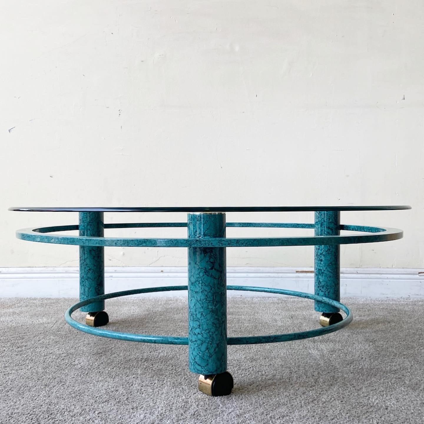 Amazing Postmodern teal blue circular coffee table. Features a circular Beveled glass top and sits on casters.
 