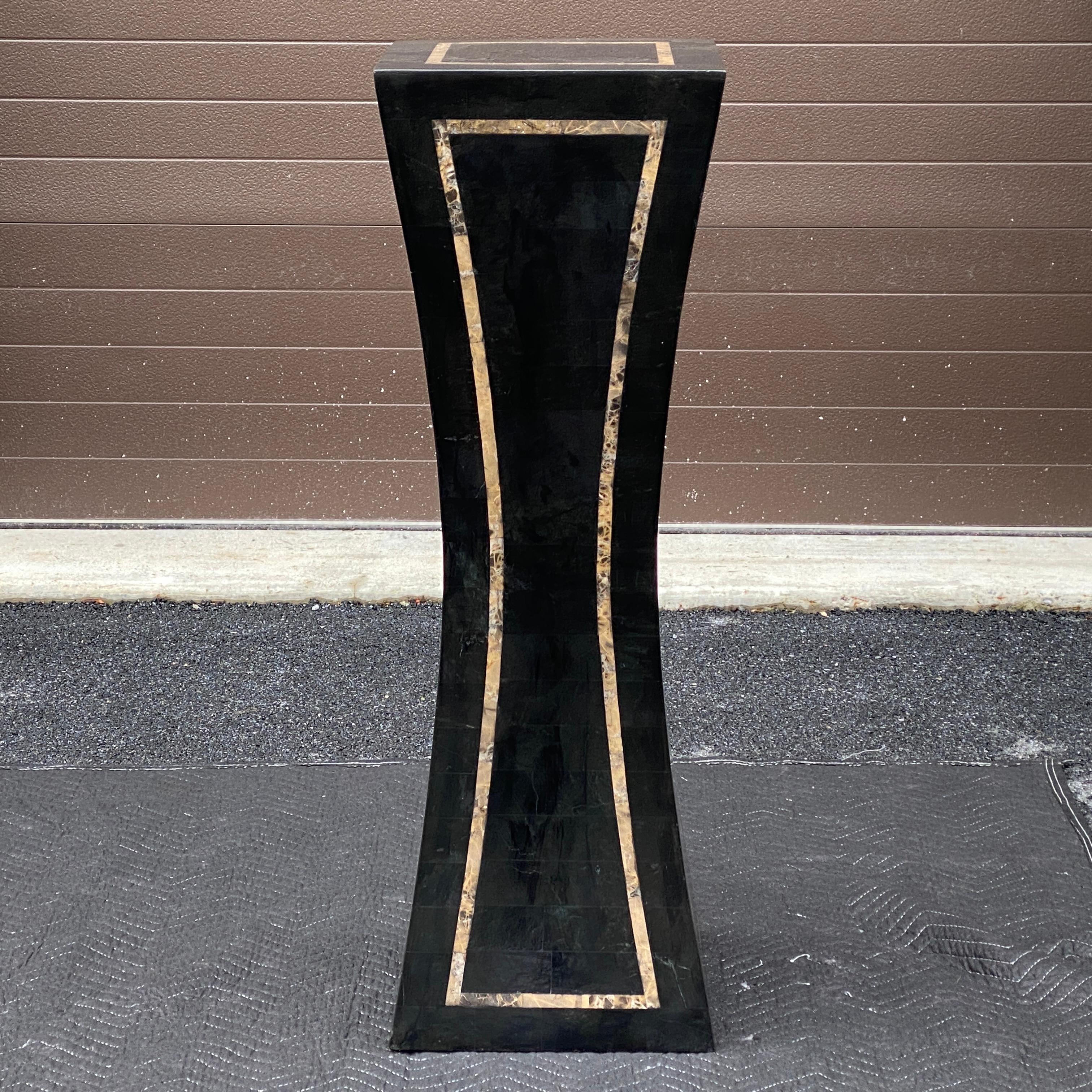 A vintage tessellated marble pedestal circa 1980s unmarked. The main color appears almost black in many indoor settings however you see more of the green tones when looking at in in direct sunlight.