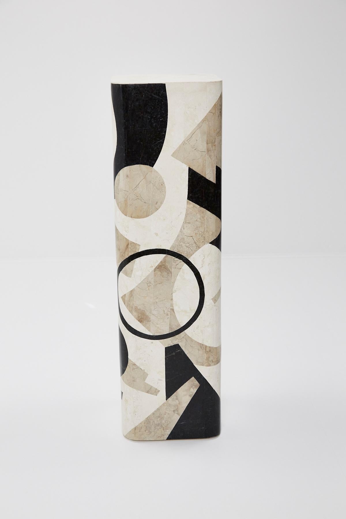 Tessellated stone pedestal. Square in shape with rounded corners. Black, cream and tan stone hand-inlaid over fiberglass body in a fun Postmodern pattern.

Measures: Tall 42 inches.

Pair available.

All furnishings are made from 100% natural Fossil