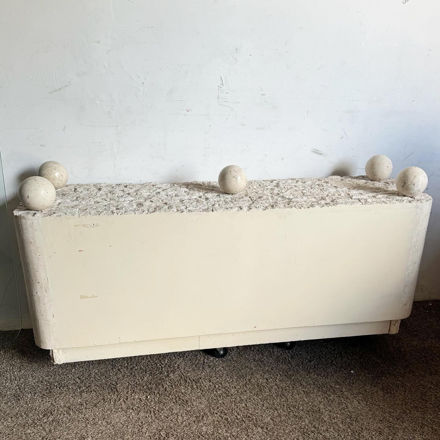 Embrace contemporary elegance with this Postmodern Stone Glass Top Credenza. Featuring a distinctive glass top supported by spherical stone accents, this piece exudes sophisticated style. The intricate tessellated stone finish adds texture and