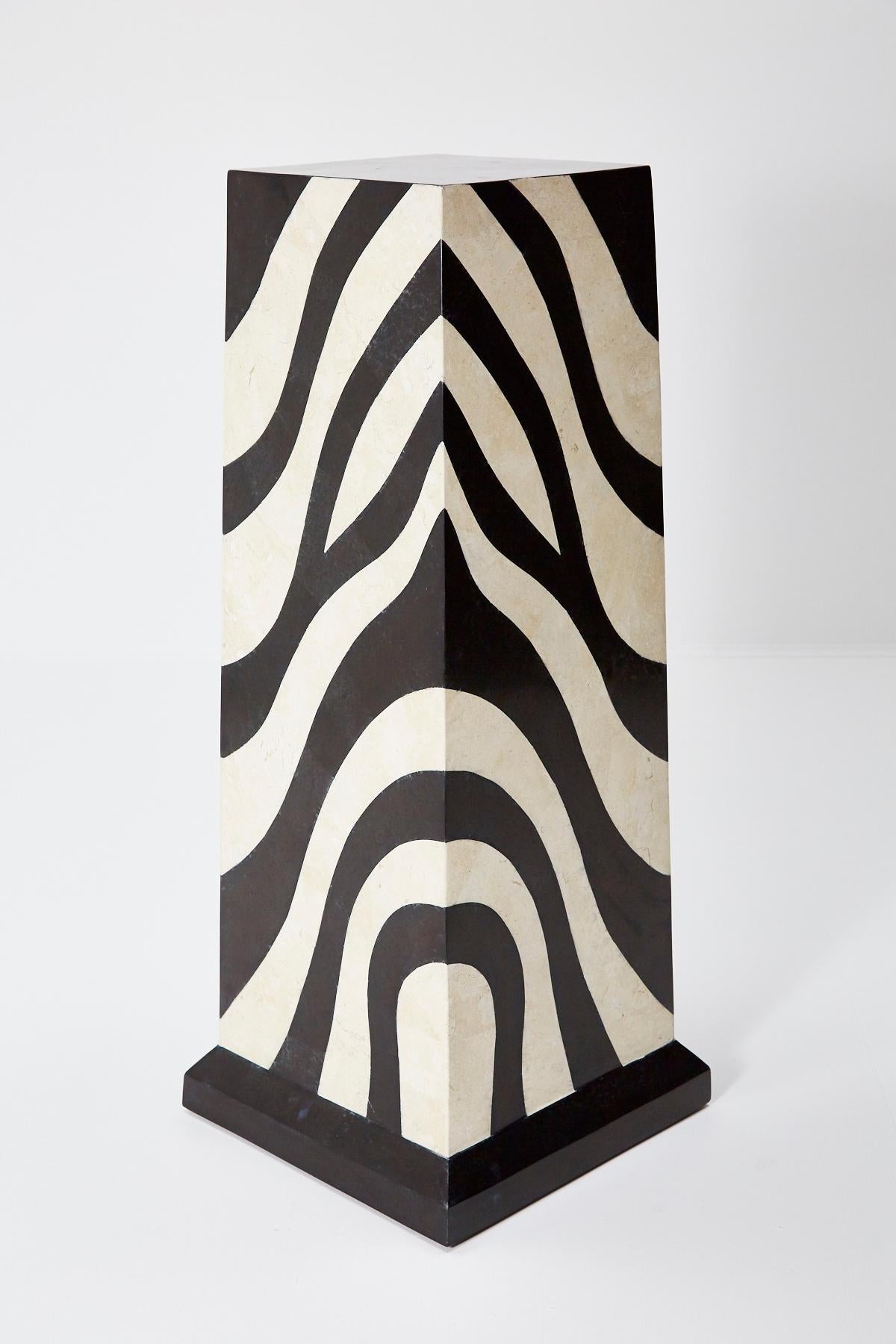 Square tessellated stone pedestal with zebra pattern and solid black base. Black and white stone hand-inlaid over fiberglass body.

Measures: Tall 42 inches.

All furnishings are made from 100% natural Fossil Stone or Seashell inlay, carefully hand