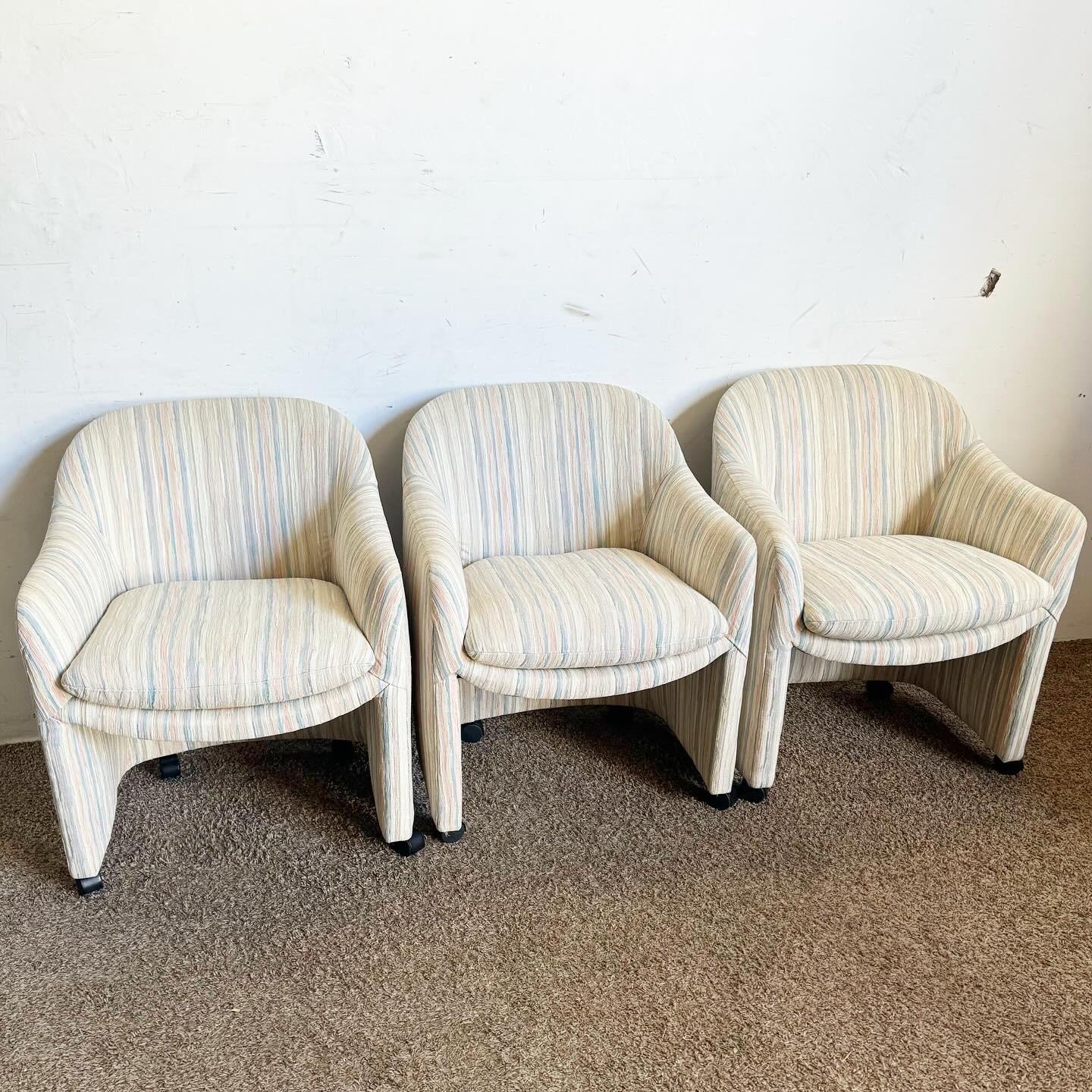 Experience the elegance of this set of 3 Postmodern Thayer Coggin Barrel Chairs on Casters. Designed with a sleek barrel-shaped silhouette and clean lines, these chairs bring modern elegance and convenience to any room. The casters allow for easy