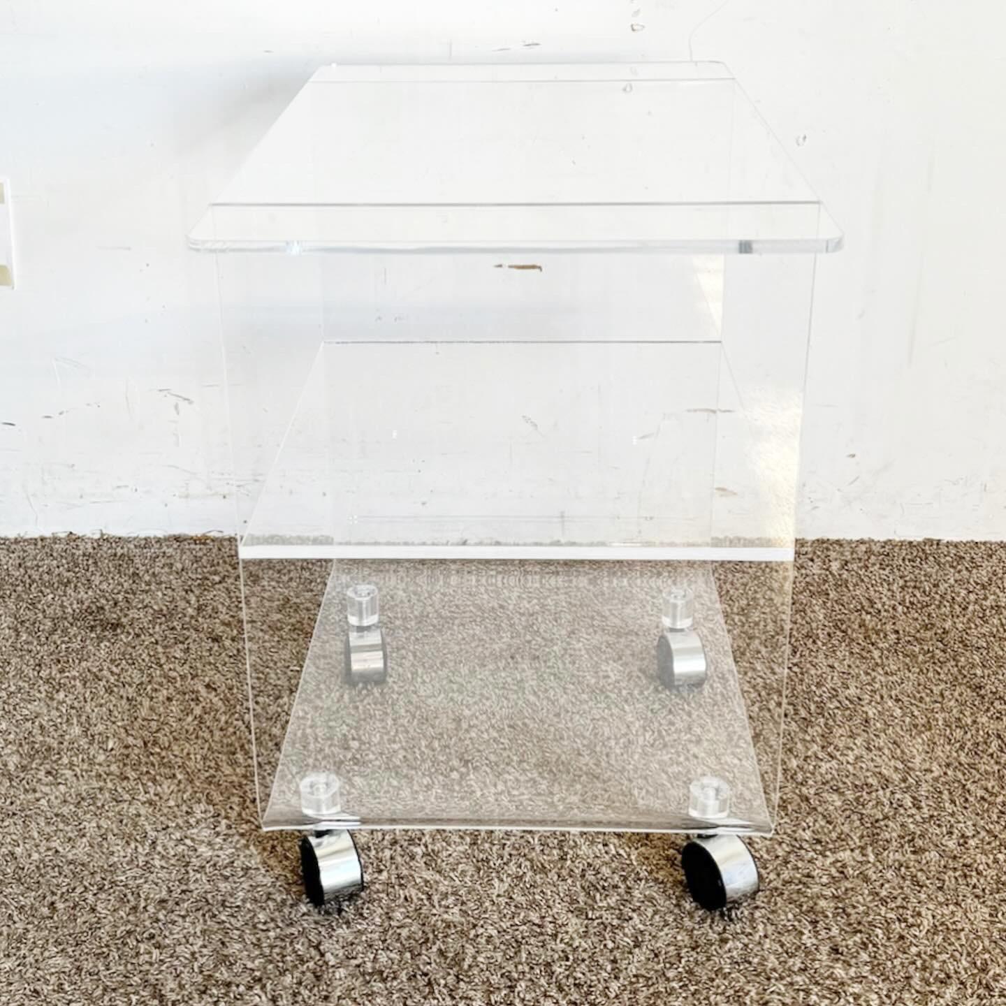 Add a touch of elegance to your hosting with the Postmodern Three Tier Lucite Bar Cart. This chic, transparent cart embodies minimalist postmodern design, offering three spacious tiers for your bottles and accessories. Its smooth mobility and airy