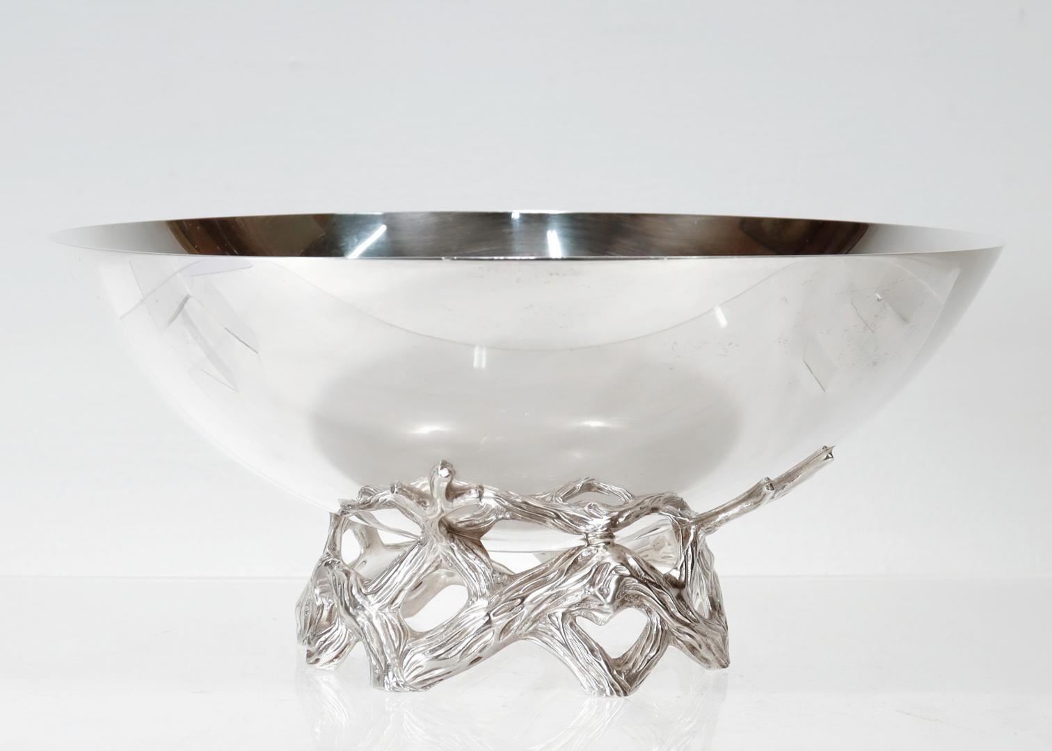 A fine Postmodern presentation or centerpiece bowl.

By Tiffany & Co.

In sterling silver.

Model No. 23886.

The bowl with a naturalistic base comprised of stylized intertwined branches or vines.

Fully marked to the base.

Simply wonderful Tiffany