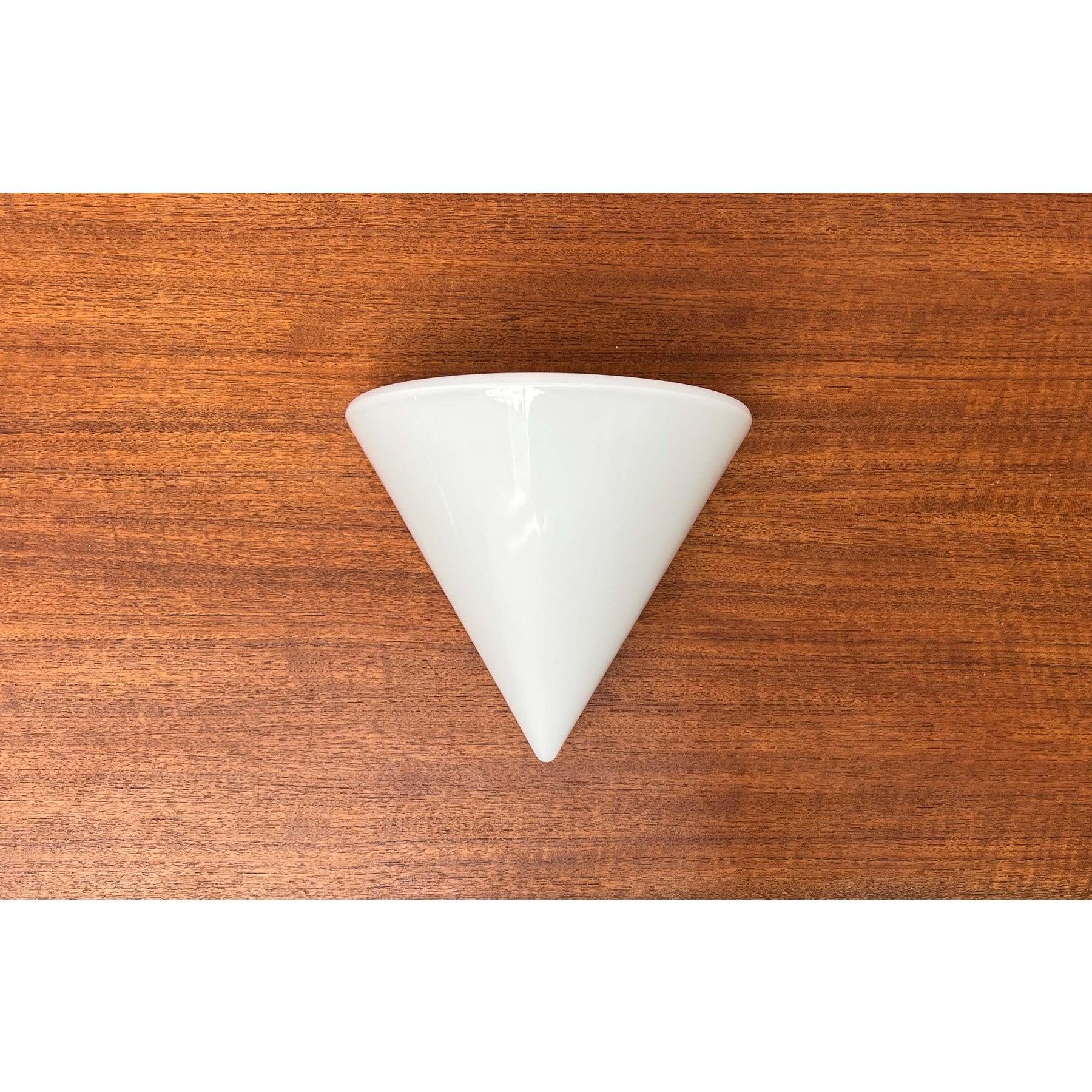 Postmodern glass wall light from the t+l royal bathroom cabinet series by keuco.

the striking shape of the lamp is particularly eye-catching. A halved cone standing on top. The lamp consists of a metal wall base and the diffuser glass. The glass is