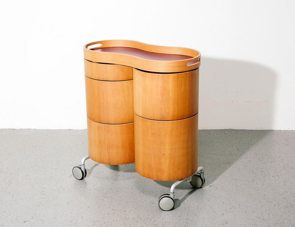 Postmodern rolling bar cart with integrated serving tray and swing-out storage canisters. Molded plywood and laminate construction.