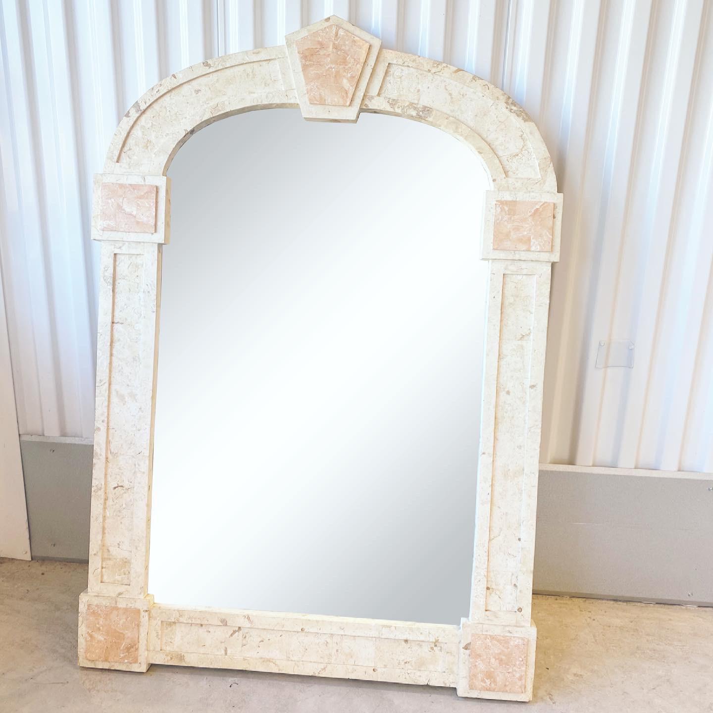 Vintage circa 1990s postmodern travertine and blush marble accent mirror. Inlaid blush marble make the accents on this travertine mirror. Monumental design and meticulously crafted. 