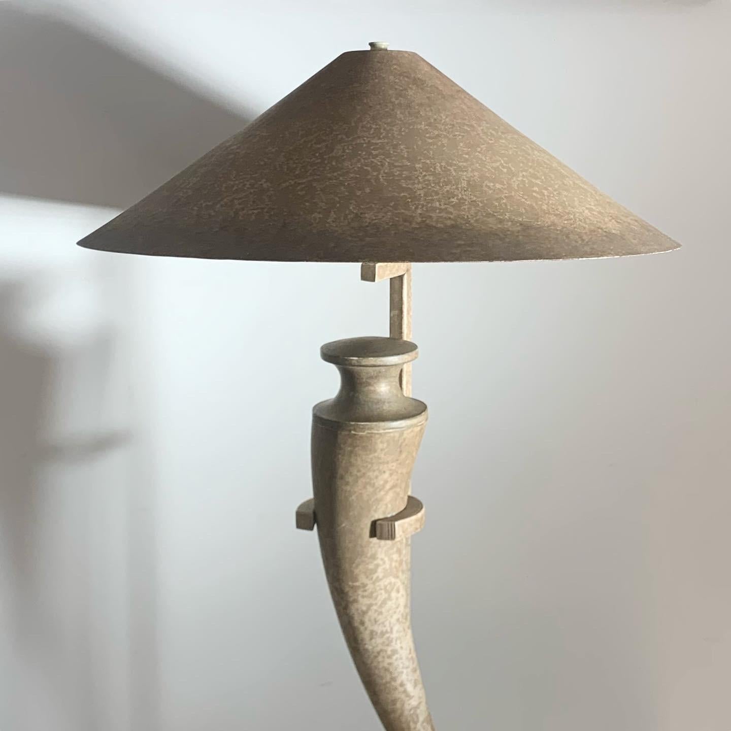 Iconic vintage « scimitar » table lamp ft. a travertine base and metal shade. Tones of pewter and taupe. Immaculate condition.
26” height, base is 8” diameter, shade is 15.5” diameter.