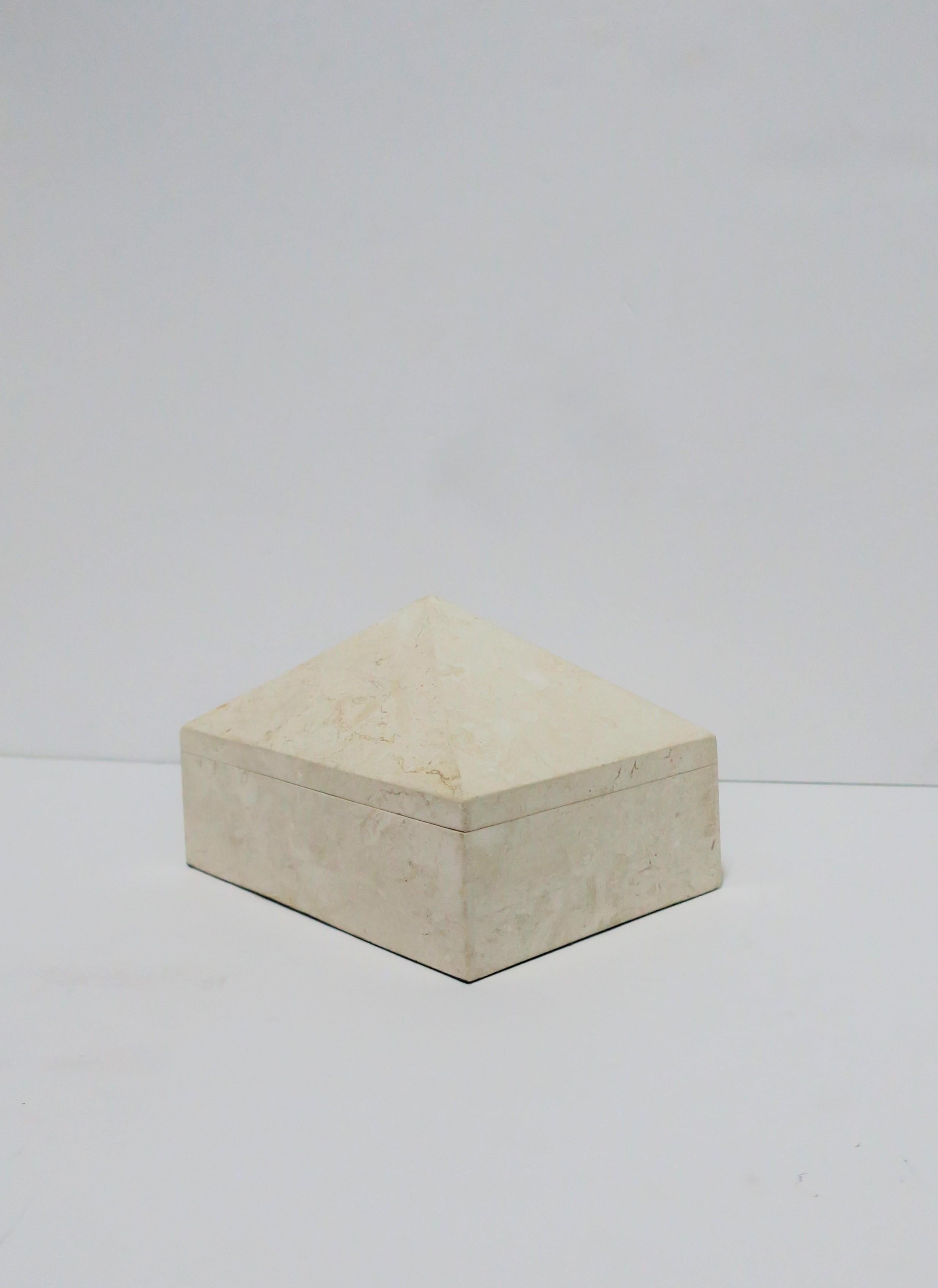 A very beautiful Postmodern [Post-Modern] or Modern style travertine marble jewelry box with pyramid top design, by designer Maitland-Smith. Travertine marble box is substantial and well made. This travertine marble box is a cream or sand color, has