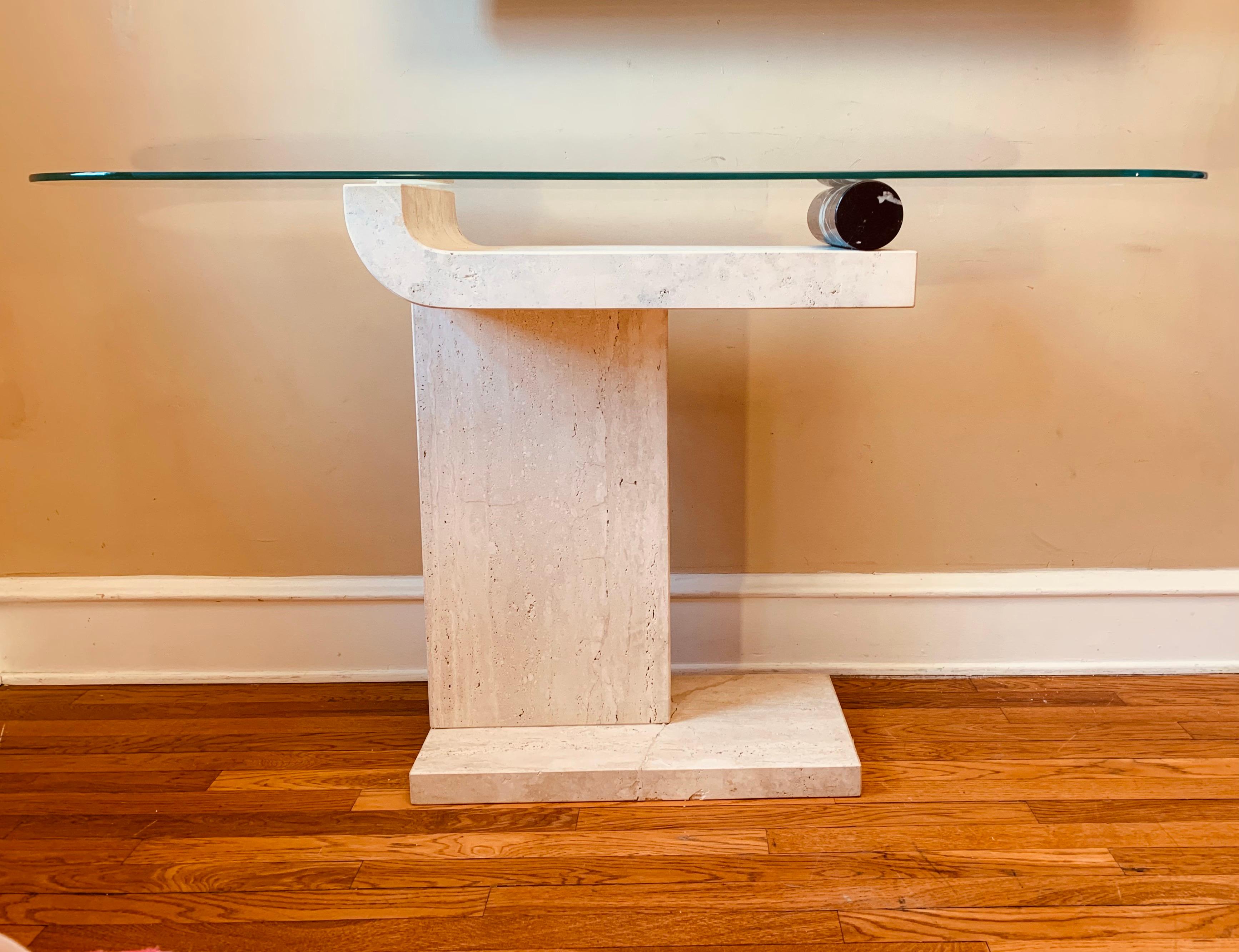 The base of this console table is truly a sculpture, and can be utilized as such sans glass.

The travertine is a deep creamy shade, with lots of rich naturally-occurring variations in the stone.

The black marble roll has nice veining and has a
