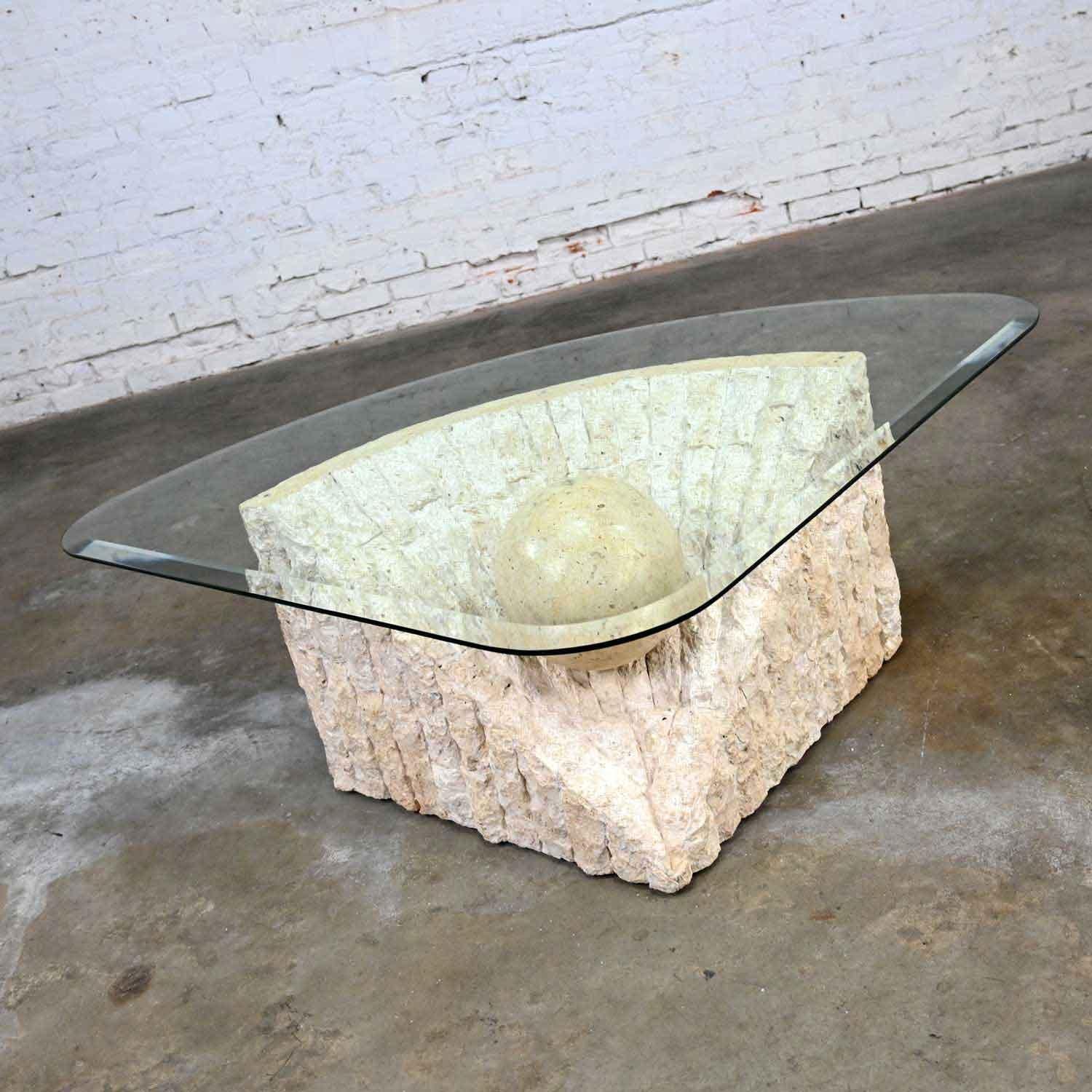 Magnificent postmodern tessellated Mactan coffee table with rough edge stone triangular base and triangular glass top with a large, polished sphere in the style of Maitland Smith. Beautiful condition, keeping in mind that this is vintage and not new