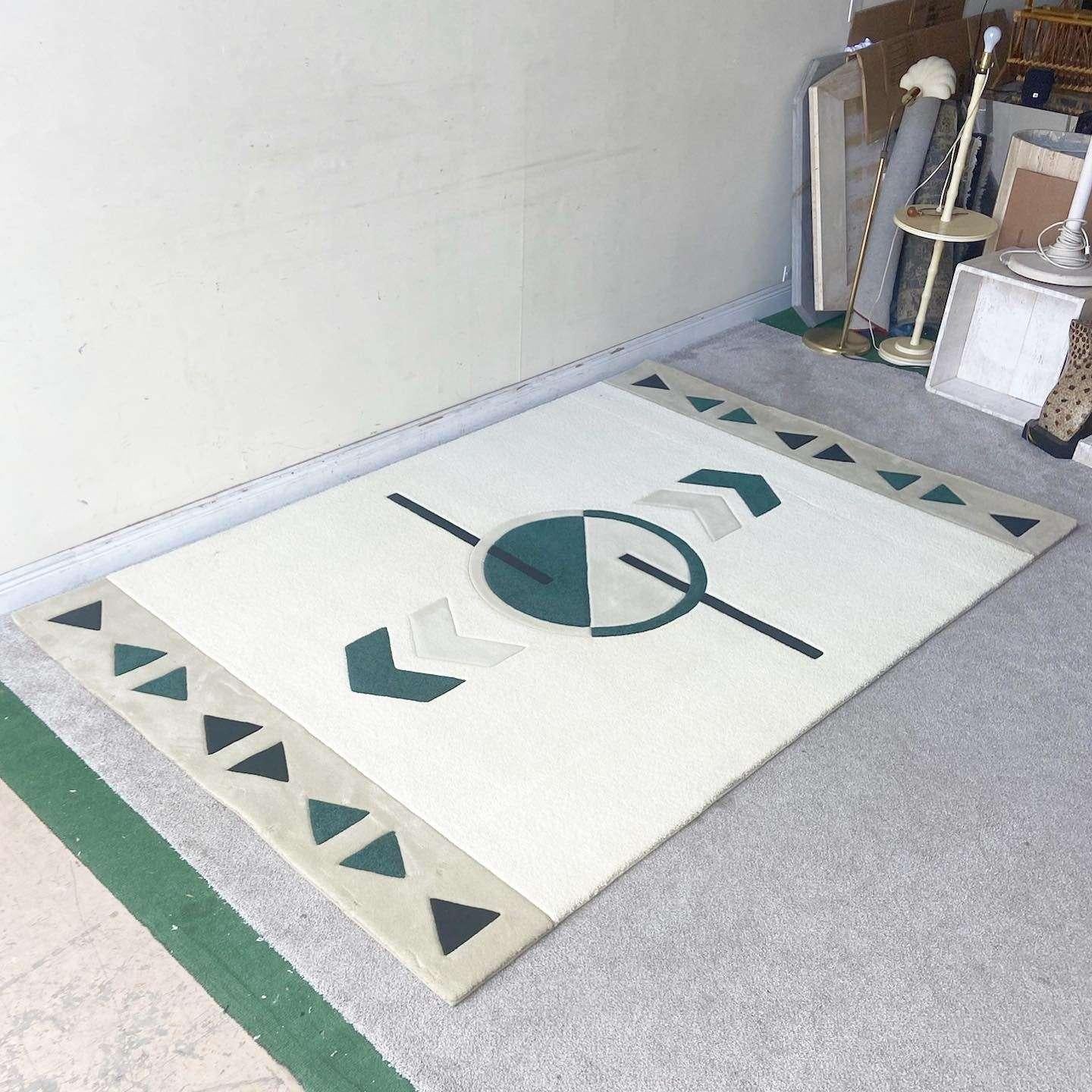 Exceptional vintage postmodern rectangular area rug. Features a green and beige design within the cream center rectangle. Bordering both sides of the rug is a tan rectangle with alternating shades of green triangles.

Rug 28
