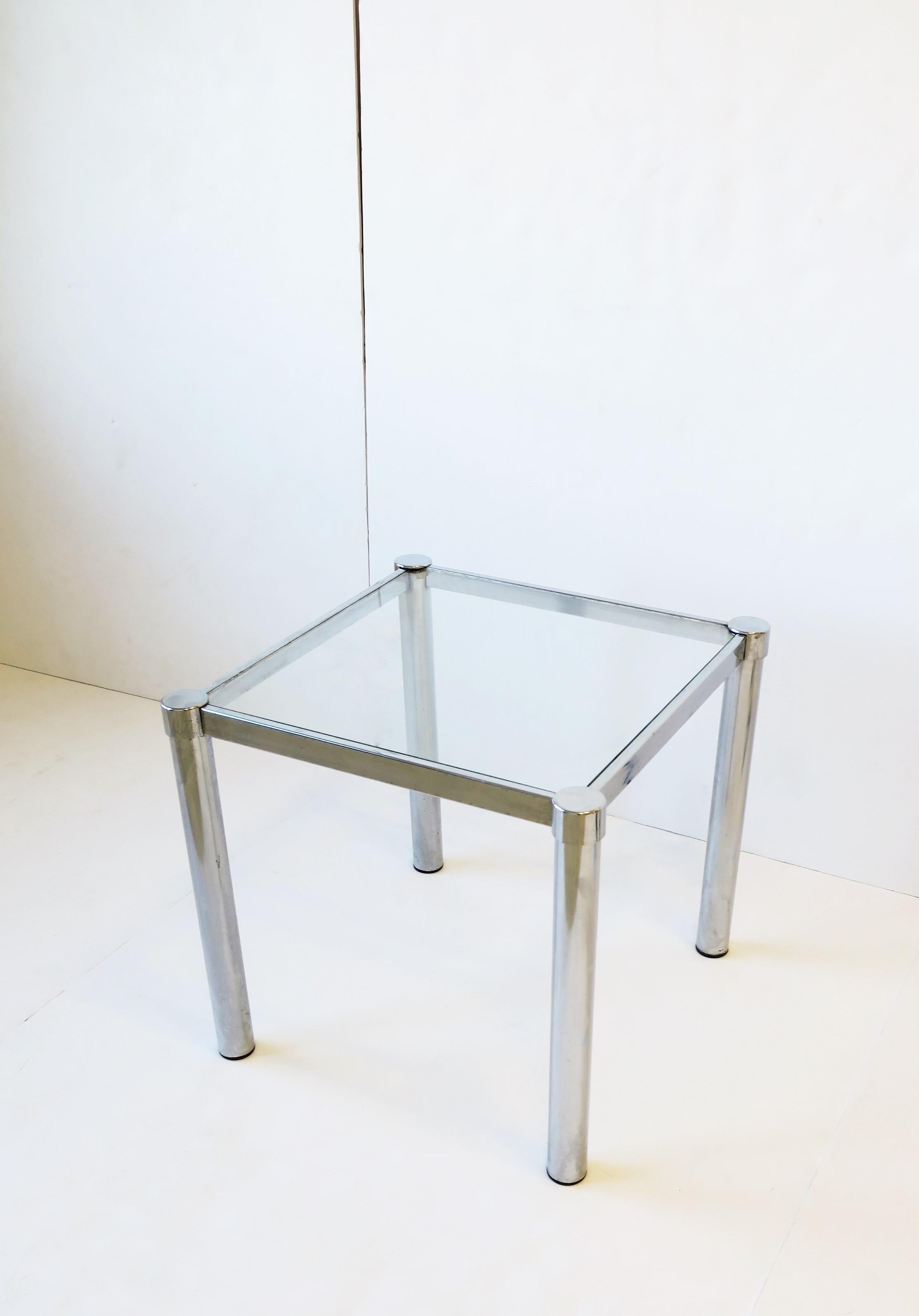 A Postmodern tubular chrome and glass end or side table, circa 1970s modern or Postmodern period. Base frame is square with tubular chrome legs, and a glass top that's fitted into base frame. Table is convenient size; Dimensions: 16