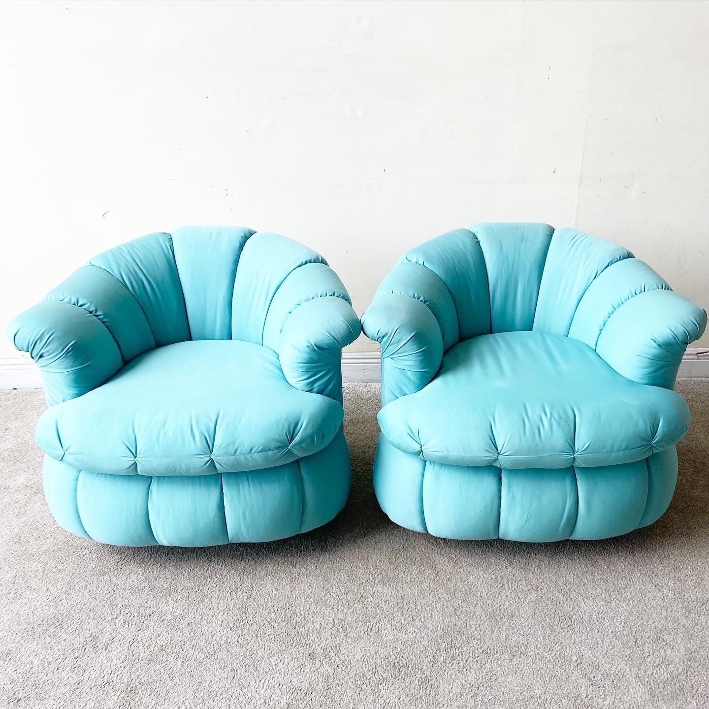 Incredible pair of postmodern swivel chairs. Each chair displays a channeled back clam shell frame with a soft turquoise blue fabric.