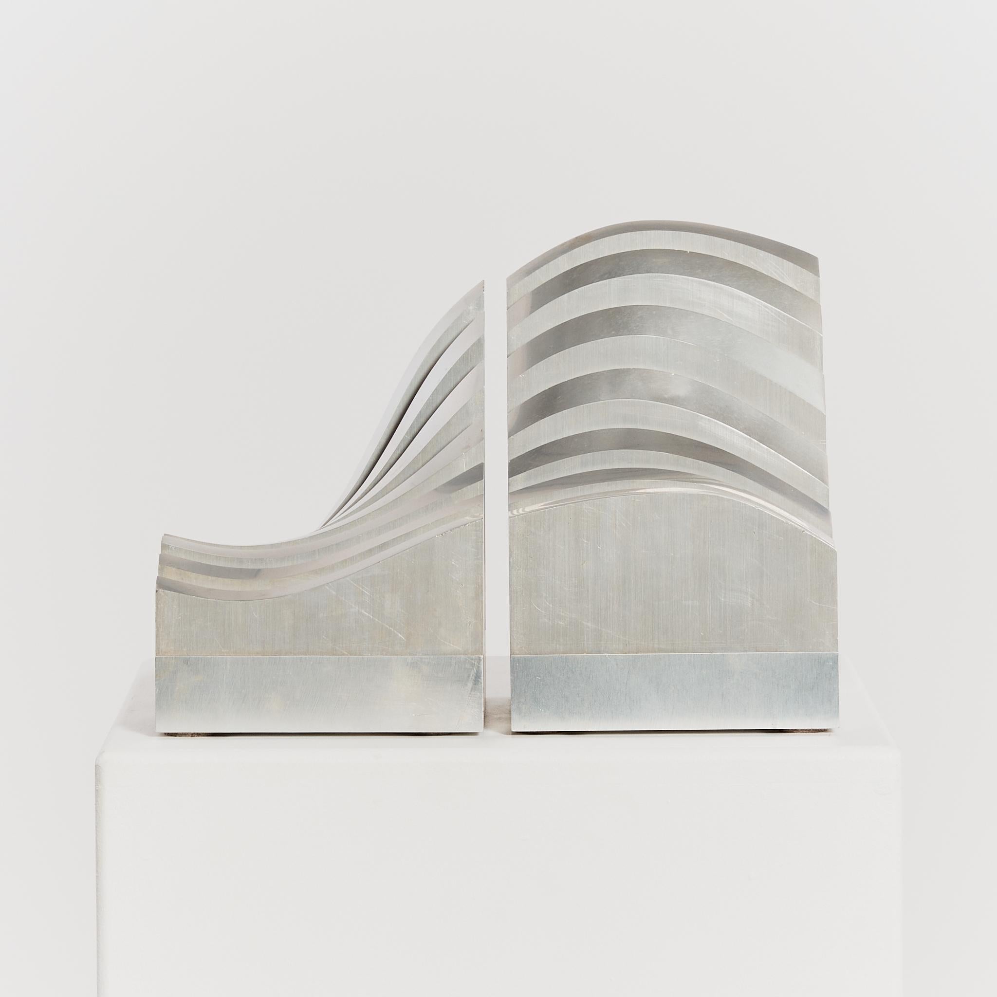 Undulating aluminium sculptures in two parts by Jiro Sugawara (b. 1941).

Origin: Japan

Artist: Jiro Sugawara

Year: 1979

Material: Aluminium

Dimensions: Approx H21 x W14.5 x D14.5cm each

Condition: Good vintage condition