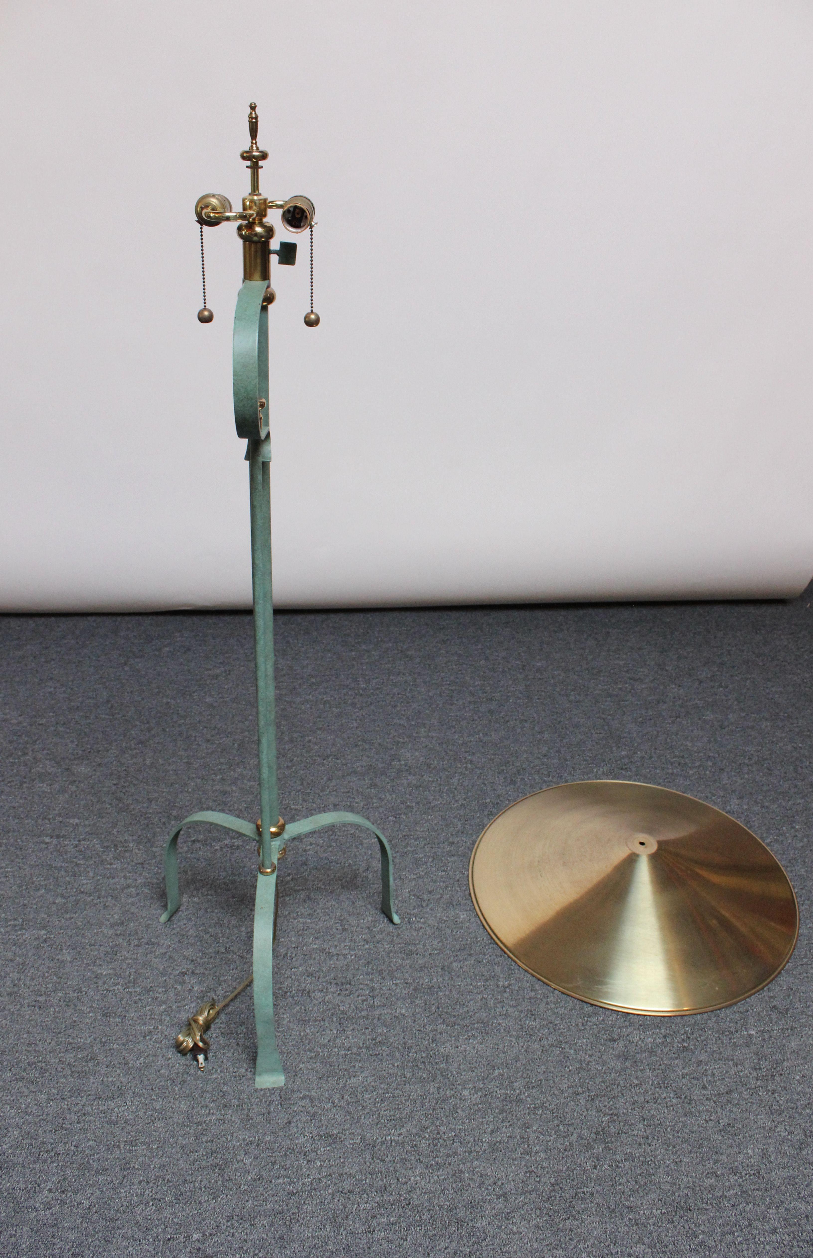 Metal floor lamp with verdigris patina, brass embellishments and the original brass shade, all supported by a tripod base (ca. 1980s, USA). Excellent, vintage condition sans minor spots of loss to the applied verdigris finish, as shown, along with