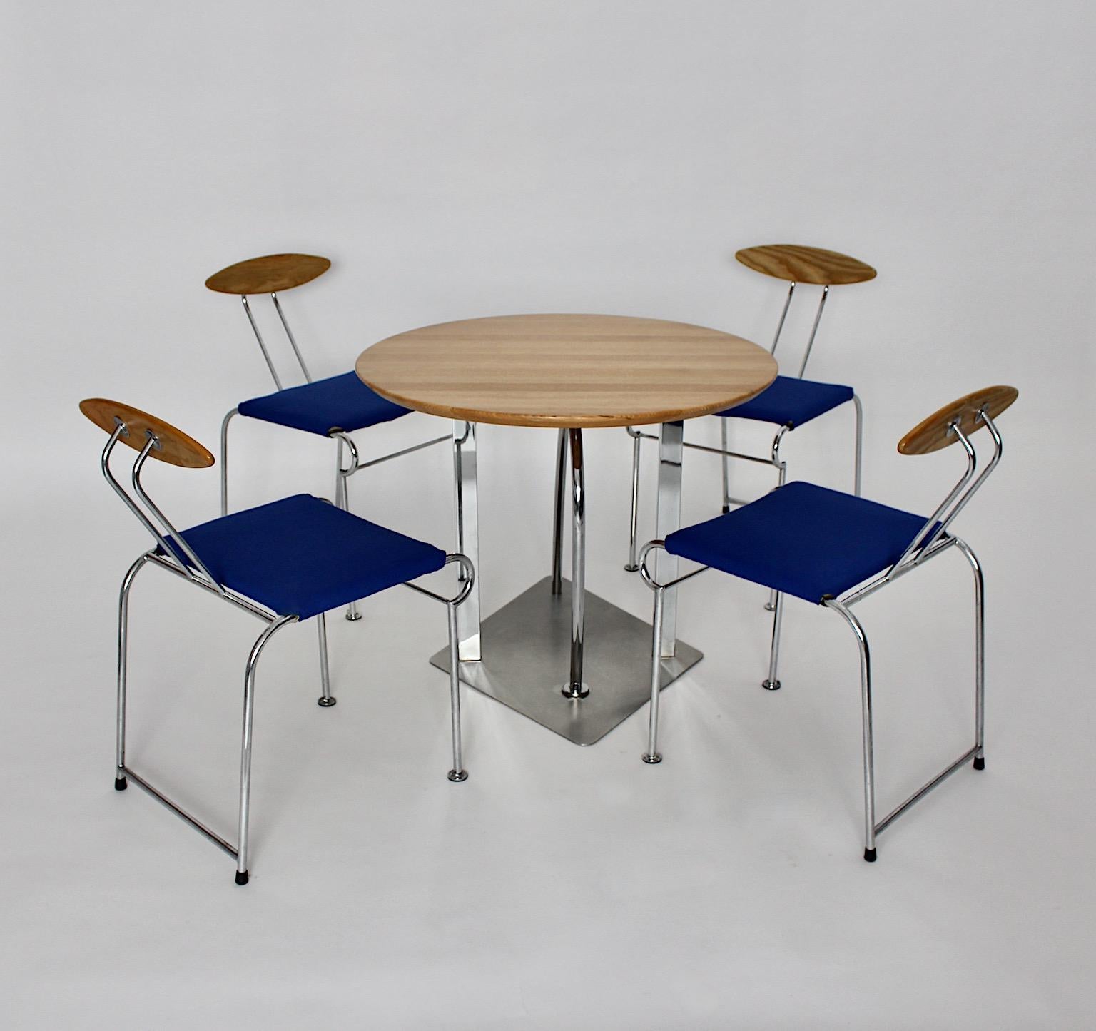 Postmodern Memphis style vintage dining room set designed by Massimo Iosa Ghini for Moroso circa 1987 Italy from ash, metal and electric blue textil fabric.
The beautiful set shows a dining table with a round plate from ash with a base construction