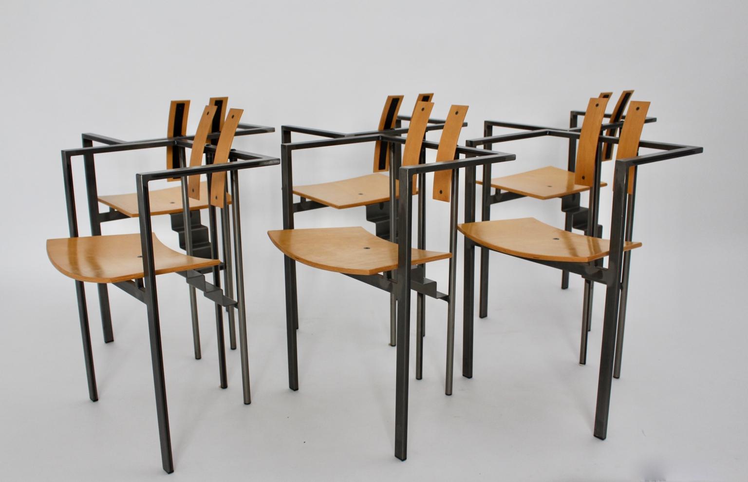 Postmodern six ( 6 )  dining chairs designed and manufactured circa 1980, Italy.
These dining chairs show a construct of sleek metal, while the seat and the back were made of natural lacquered beech plywood.
Please draw your attention to the