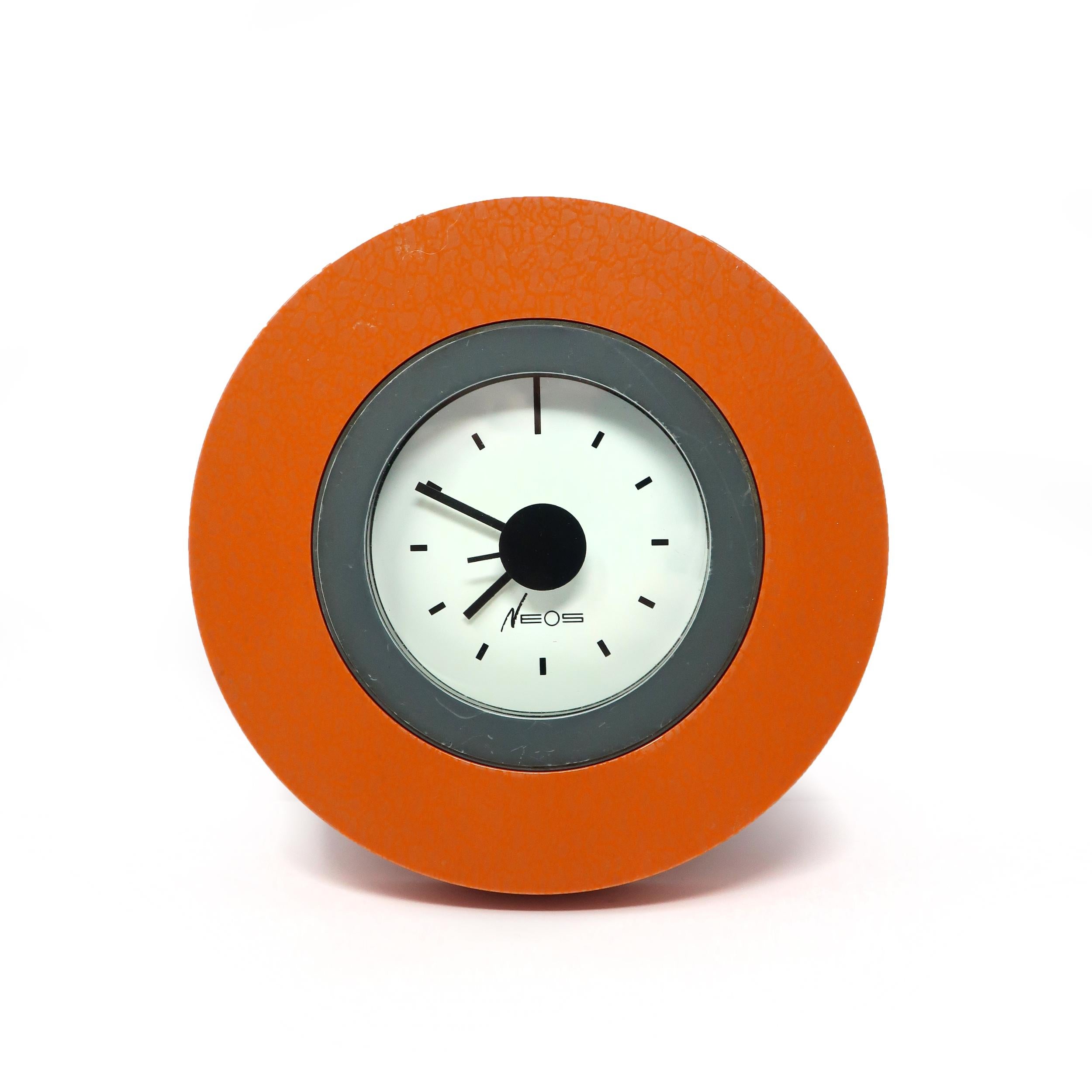An amazing orange and gray wall clock designed by Memphis Group founding members George Sowden and Nathalie du Pasquier for Neos of Lorenz.  Orange plastic case with a very subtle iridescent elephant print, gray inner circle on front, white face