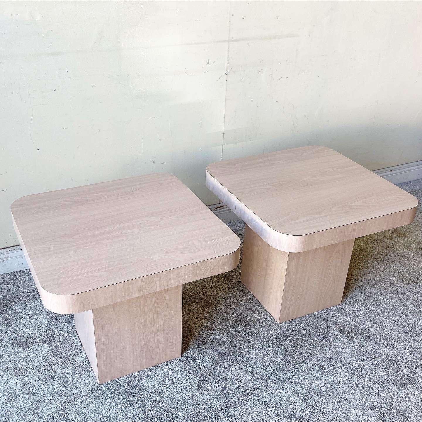 Exceptional pair of postmodern mushroom side/end tables. Features a “washed” Woodgrain laminate with rounded corners.