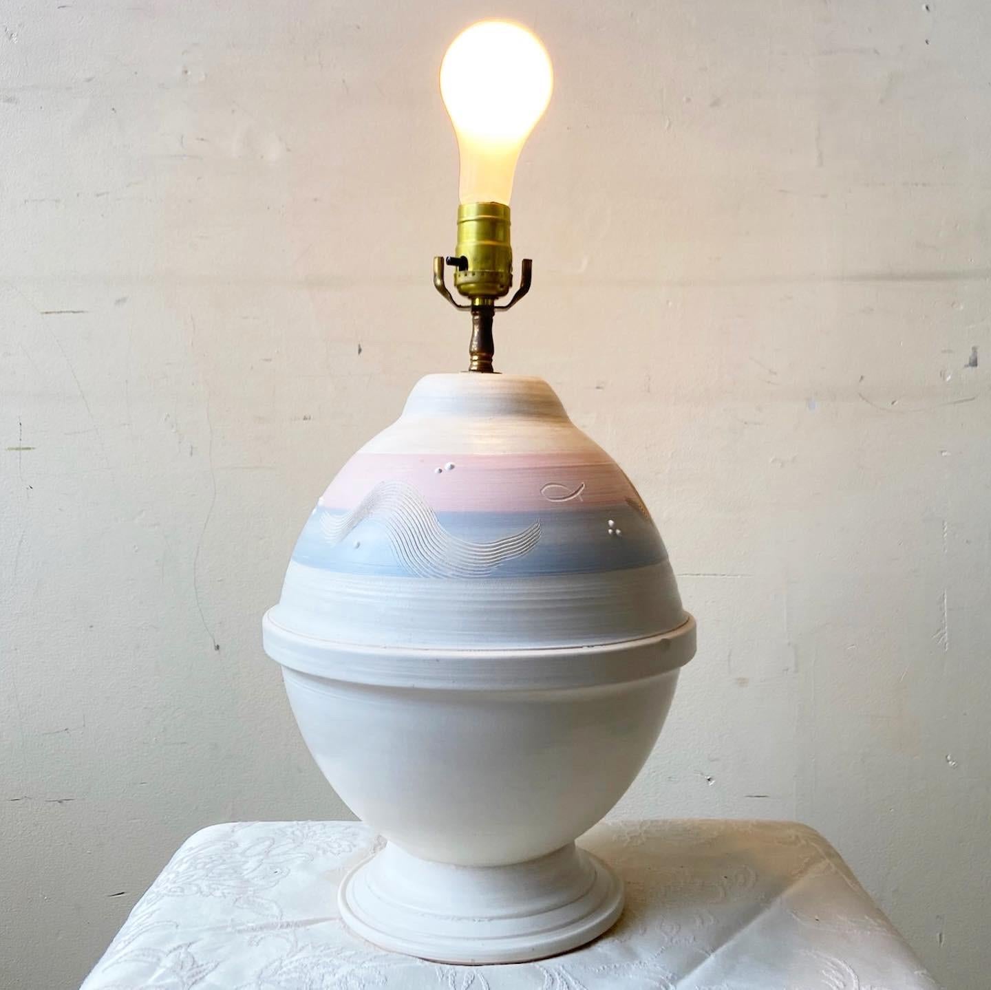 Exceptional postmodern sculpted pottery table lamp. Features an incredible off white, pink and blue finish.

Additional information:
Material: Pottery
Color: Off-White
Style:Postmodern
Time Period: 1980s
Place of origin: USA
Dimension: 10ʺ W × 10ʺ D