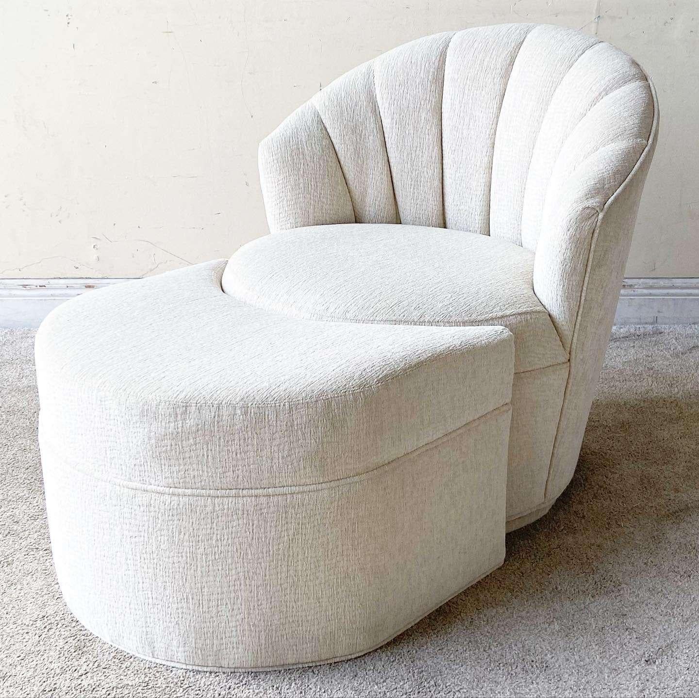 Amazing vintage postmodern white fabric swivel chair with a nesting, crescent shaped foot rest/ottoman. Features a clam shell channeled backrest.

Foot rest measures 26”W, 22”D, 16.5”H

Seat height is 17.5 in