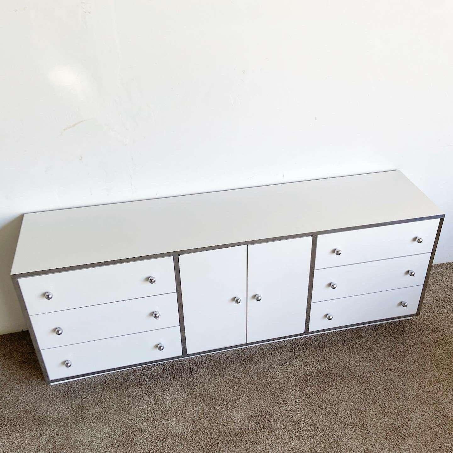 Amazing vintage postmodern rectangular dresser. Features a white lacquer laminate with chrome trim and knobs.
