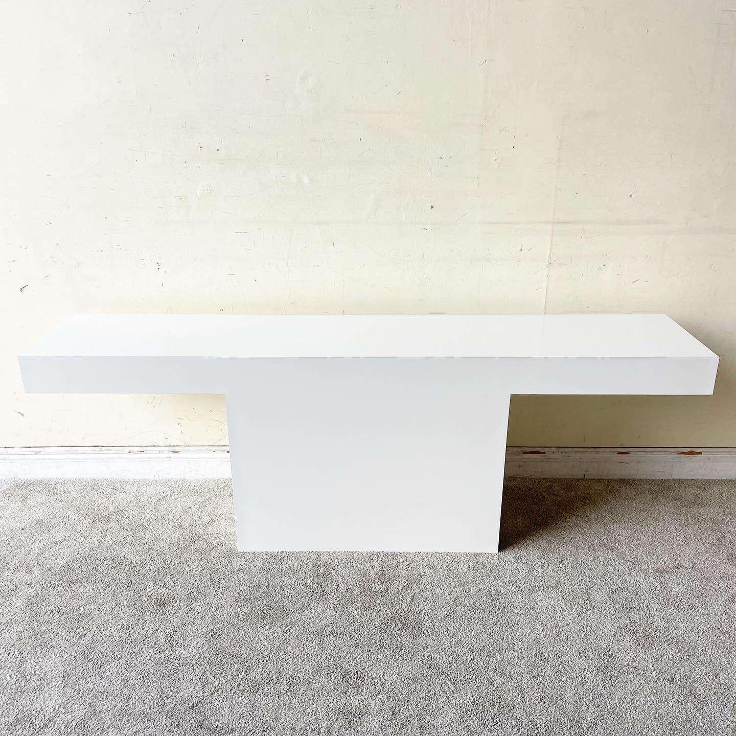 Amazing vintage postmodern T shaped console table. Features a white lacquer laminate throughout the surfaces.
