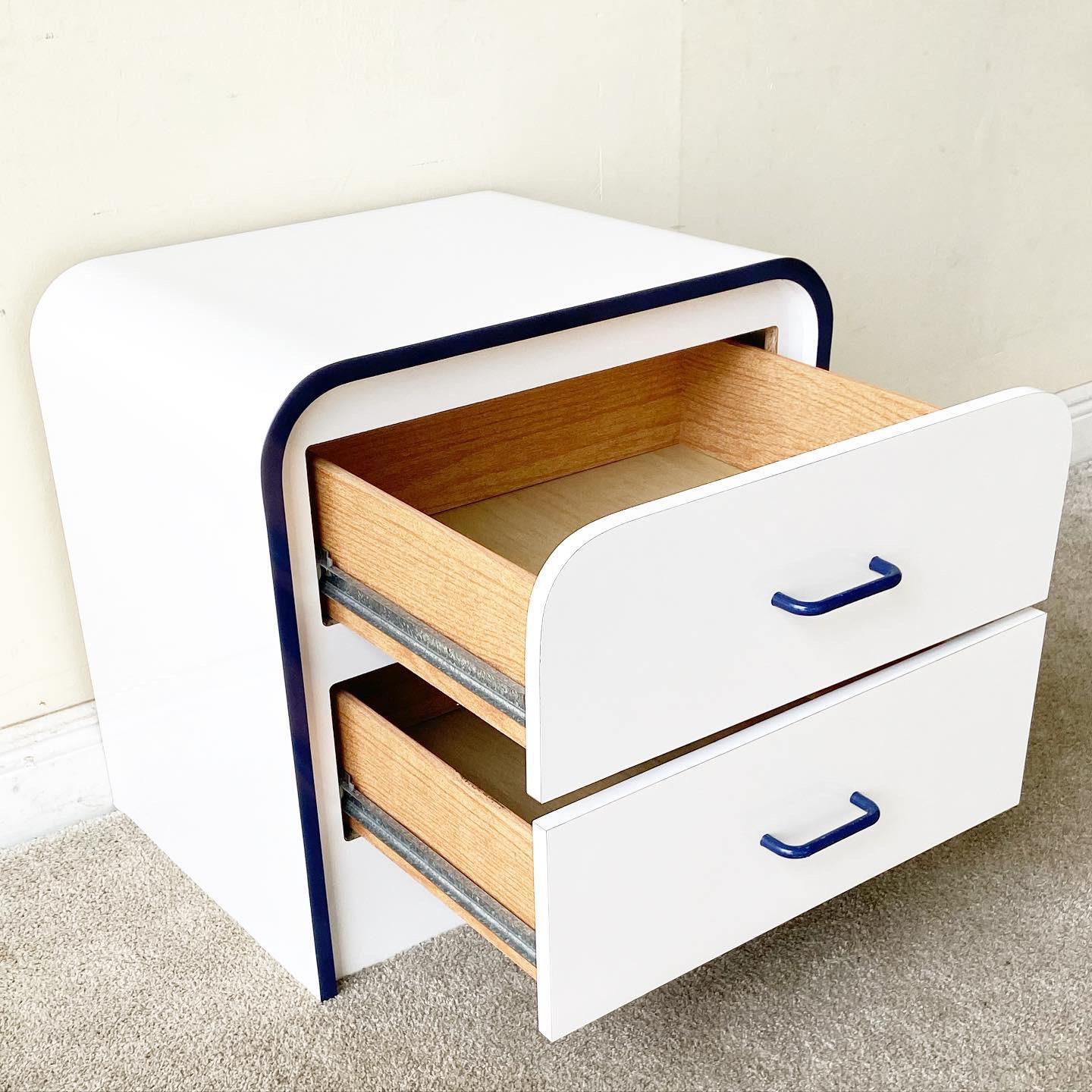 Exceptional postmodern white and blue lacquer laminate waterfall nightstand. Features two spacious drawers with blue drawer pulls.
 
