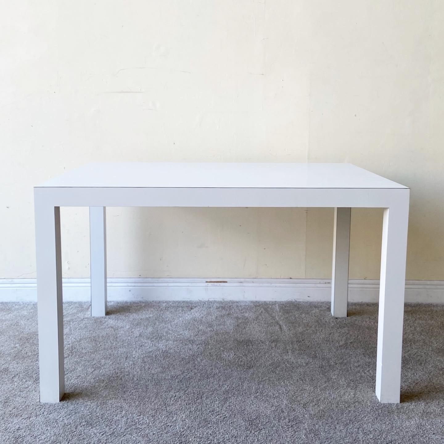 Amazing 1980s postmodern Parsons dining table. Features a white laminate.
 