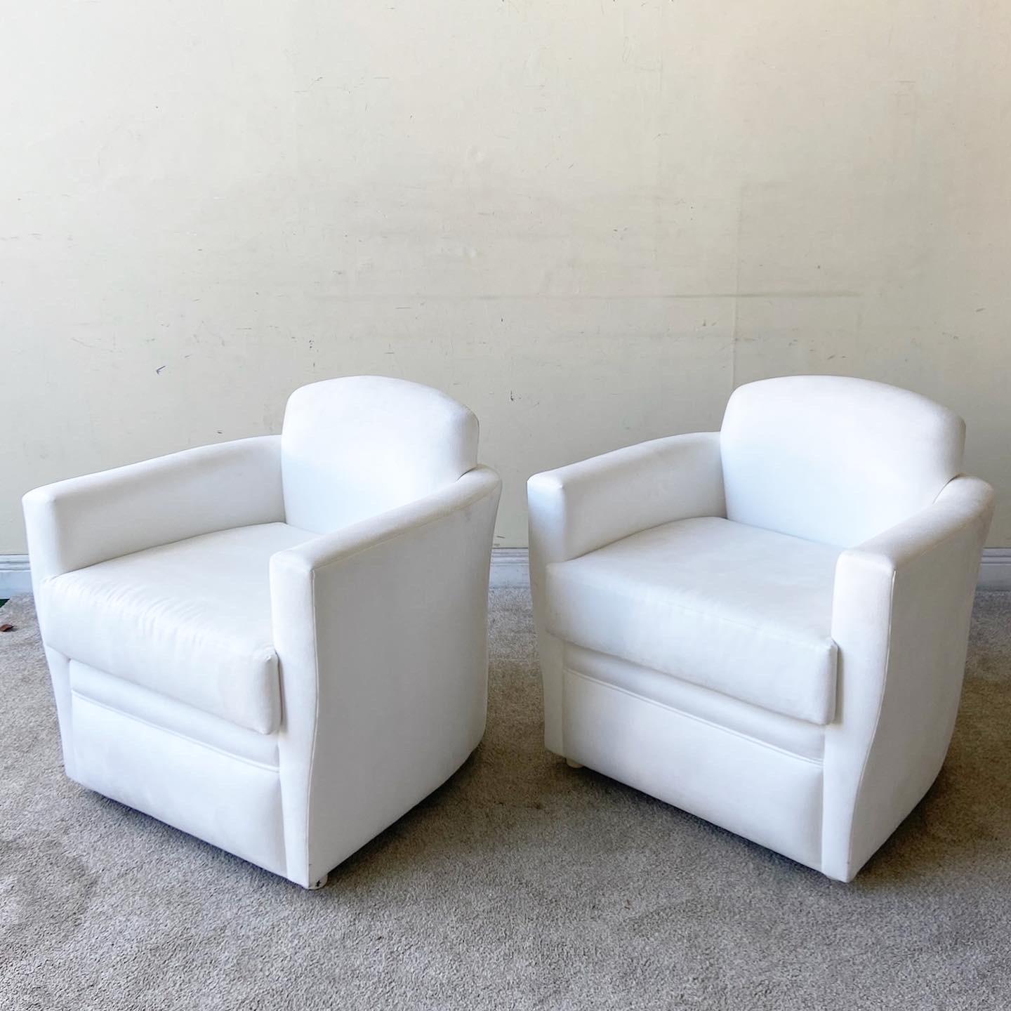 Amazing pair of vintage Postmodern lounge chairs. Features a white micro suede upholstery with matching pillows.
