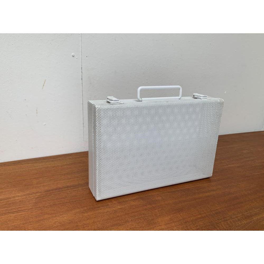 Postmodern White Perforated Metal Briefcase, 1980s, in Very Good conditions. Designed 1980 to 1989.

Additional information:
Materials: Metal
Styles: Postmodern
Color: White
Item Type: Vintage, Antique or Pre-owned
Dimensions: 11.42ʺW × 10.63ʺD ×