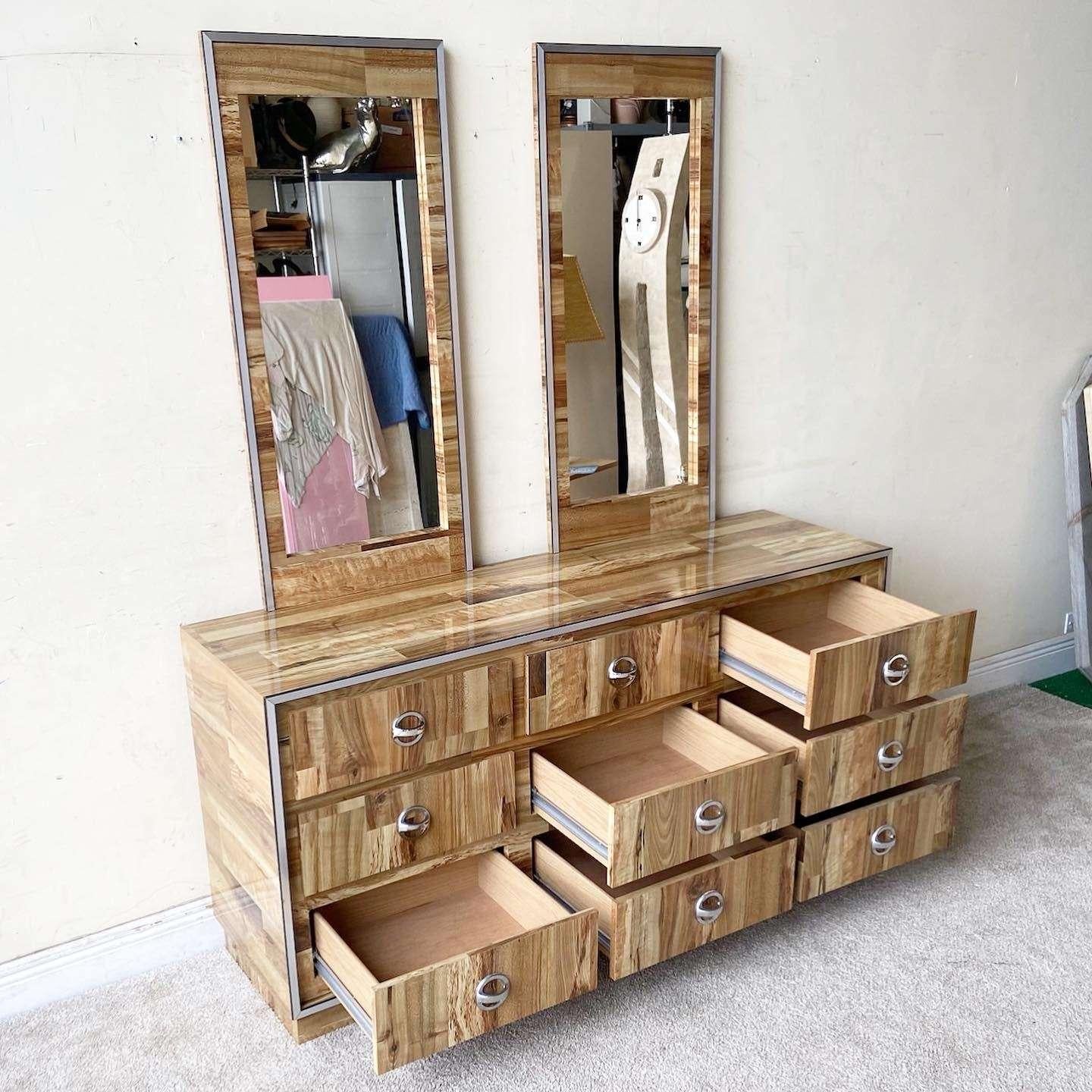 Exceptional vintage postmodern triple dresser with two matching mirrors. Each features a Woodgrain laminate with a silver edges.

Each mirror measures 19.5”W, .75”D, 43”H
