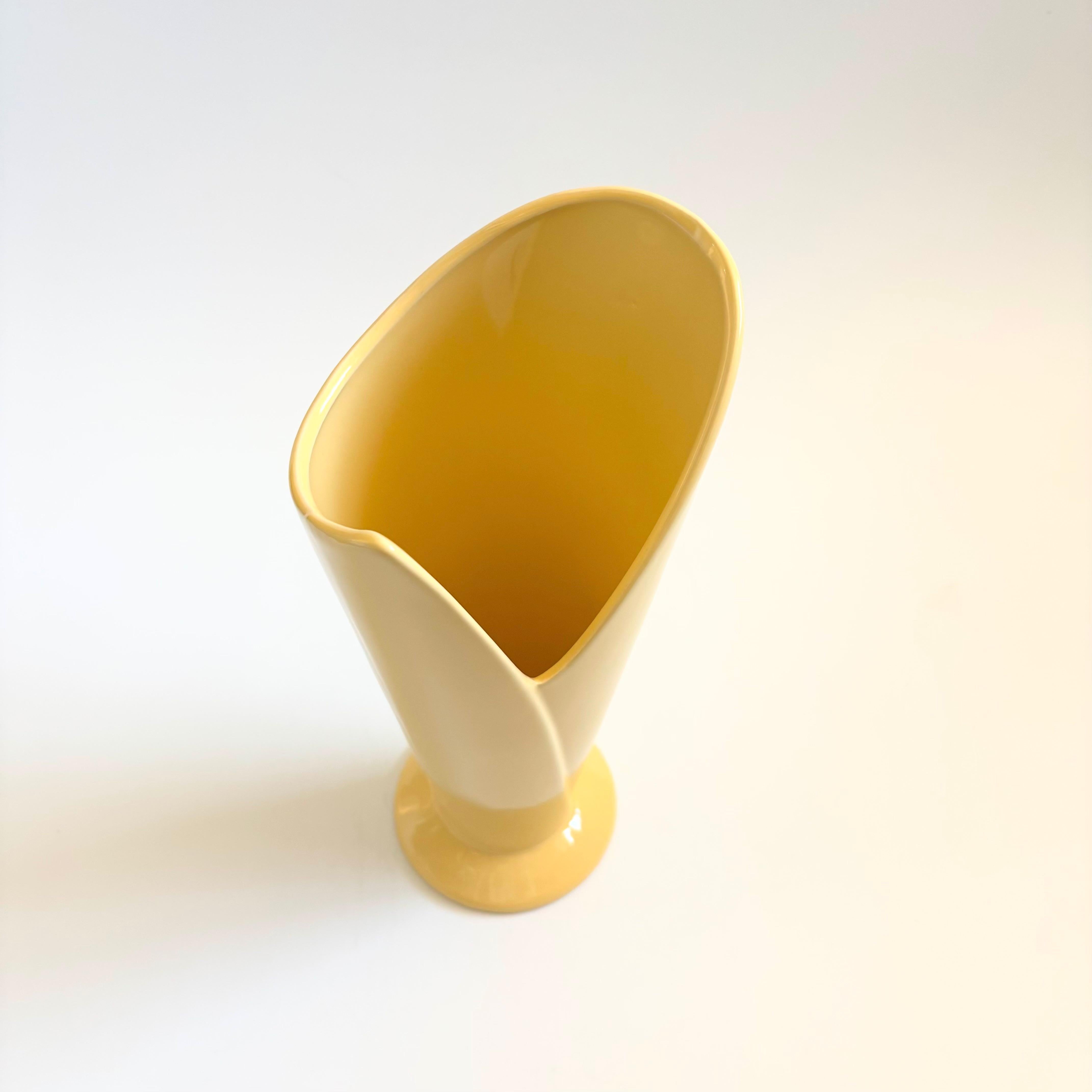 A vintage 80s postmodern ceramic vase. Unique wrapped design, finished in a glossy pale yellow glaze. Nice large versatile size.

