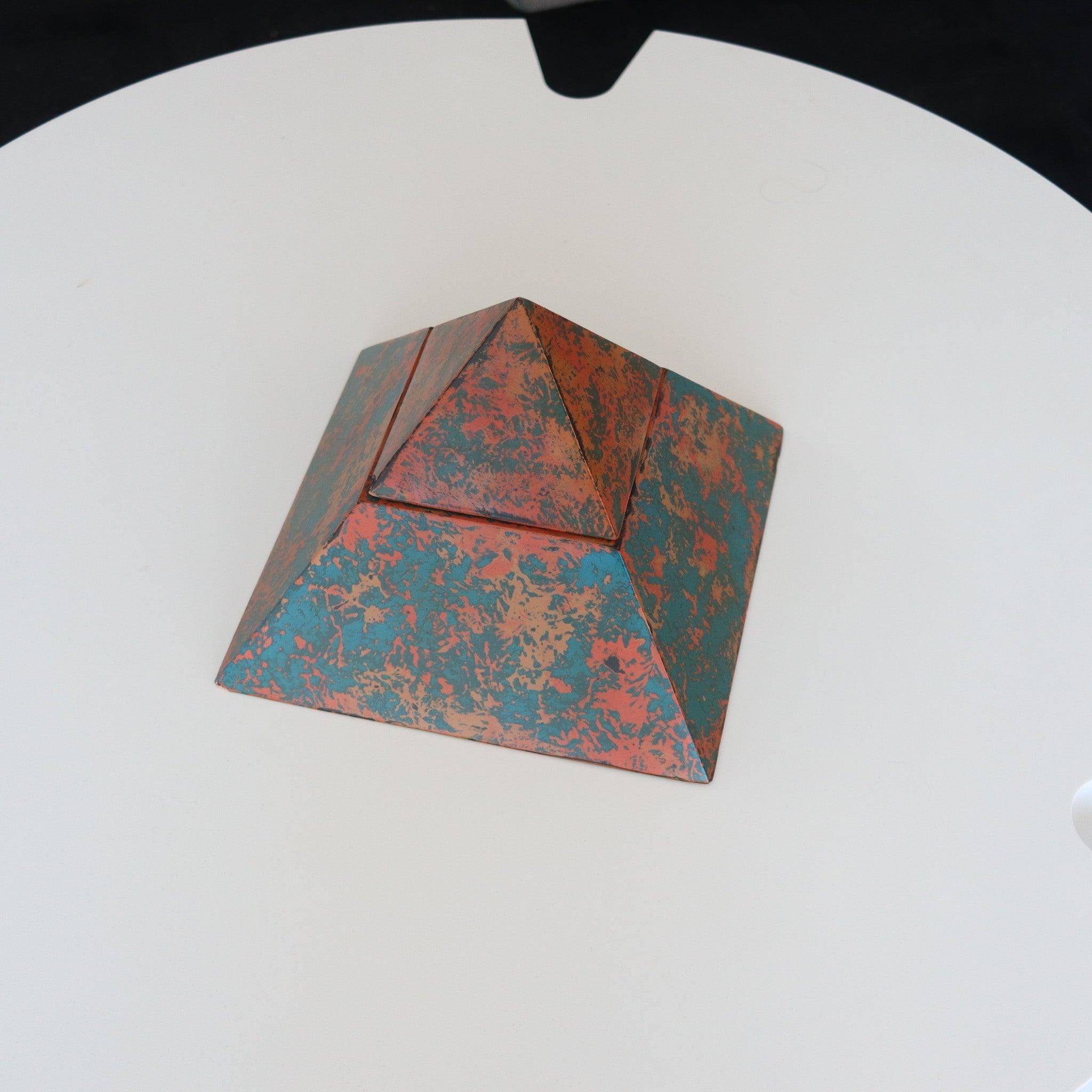 A postmodernism pyramid shaped box.

This is an amazing and very decorative vintage box created during the postmodernism period and dated by the artist 1992. The decorative box is an early work by Watson, crafted in the shape of a pyramid in solid