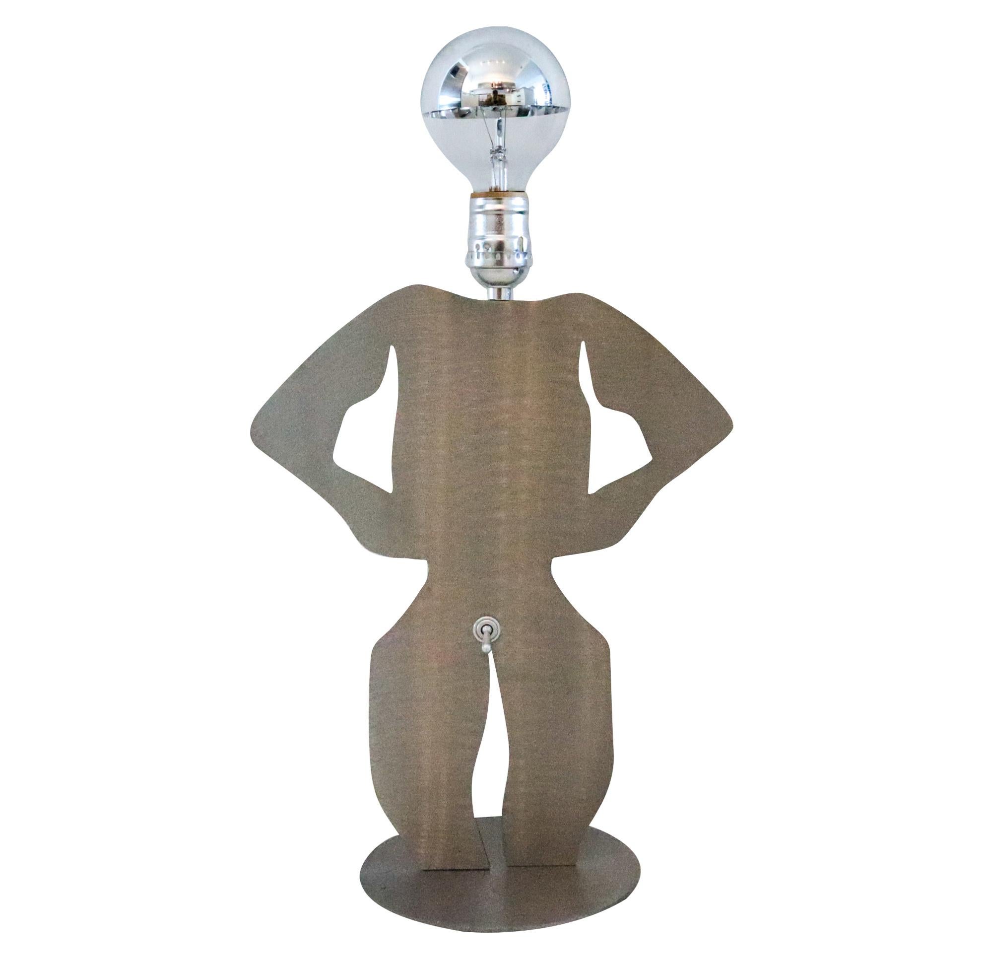 An op-art postmodernist lamp.

Unusual postmodernist pop art lamp created with memphis design patterns in the continental United States back in the 1980's. Crafted with the silhouette of a clothes off standing man in solid cut stainless steel.