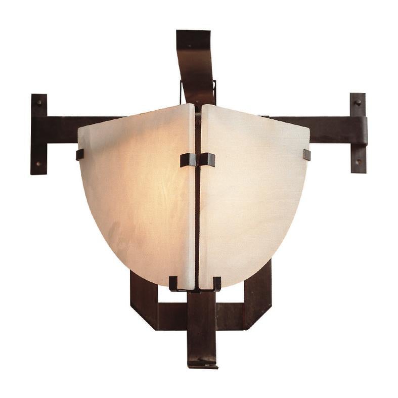 Designed in 1922, this wall lamp is symbolic of Pierre Chareau's cubist inspiration. Like a statue, it stares out from the two alabaster panels forming the face, the metal forming the body. 