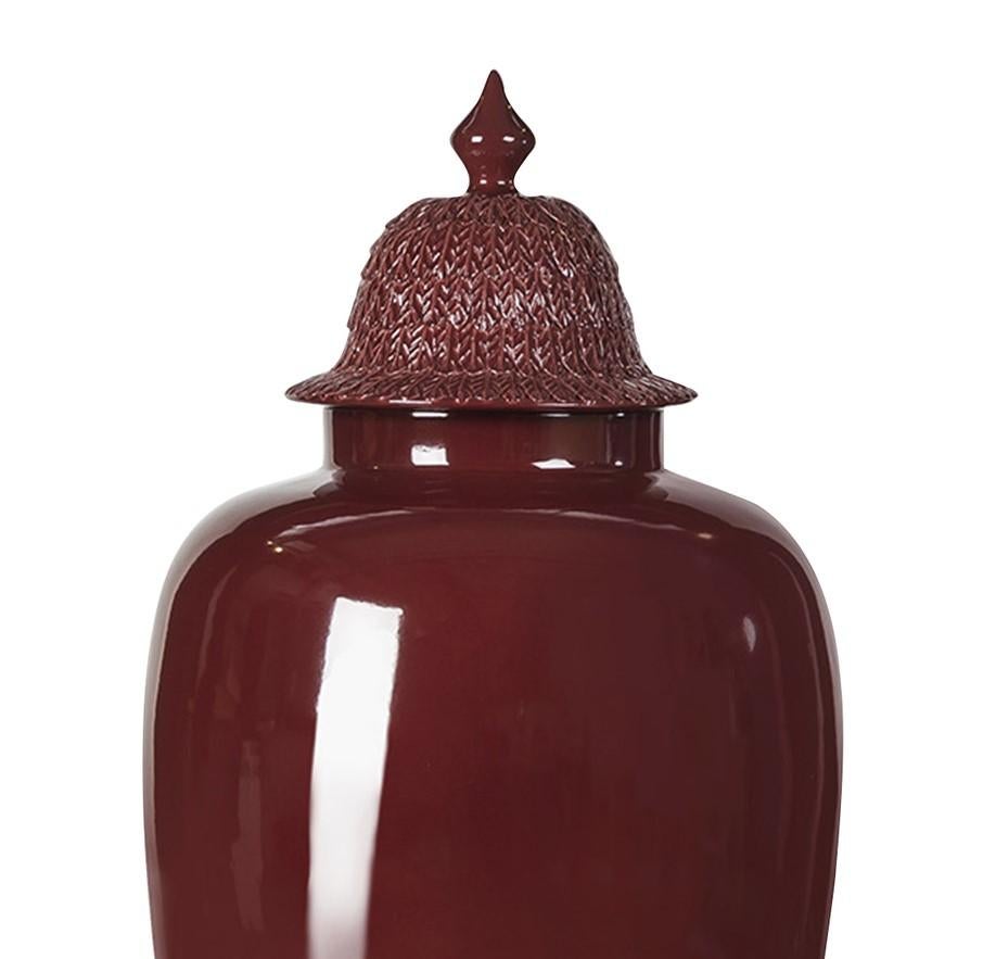 This elegant vase with lid is a stunning decorative piece to display on a console in an entryway, on a mantelpiece in the living room, or in a bookcase in the study. Handmade of ceramic, its imposing size and sinuous body is adorned with a stunning
