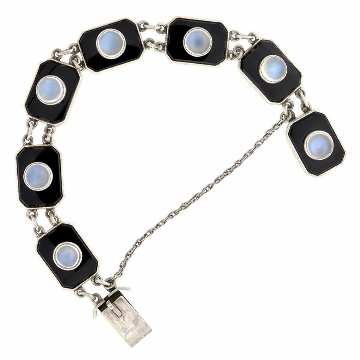 A gorgeous onyx link bracelet from the late Art Deco (1930s) era by Potter & Mellen, a renowned jeweler from Cleveland, Ohio. This unusual piece is crafted in sterling silver, and comprised of seven stylish links that come together to form a