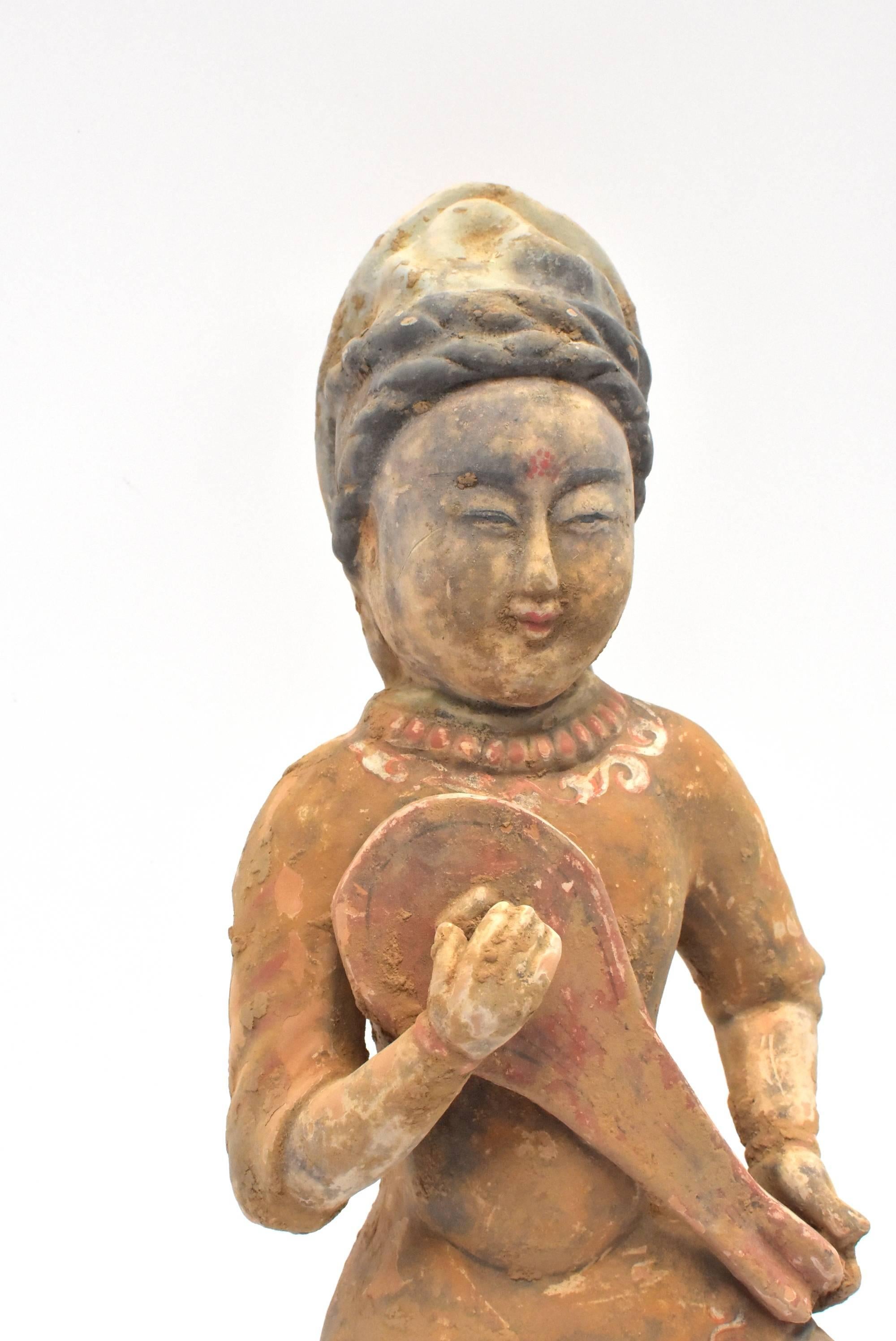 A fantastic Tang style terracotta figure. Such a figure is seen in the Han dynasty dating 206 BC-220 AD. The figure is of a central Asian musician. Her headdress and facial features indicate she is from north western region, likely central Asia. She