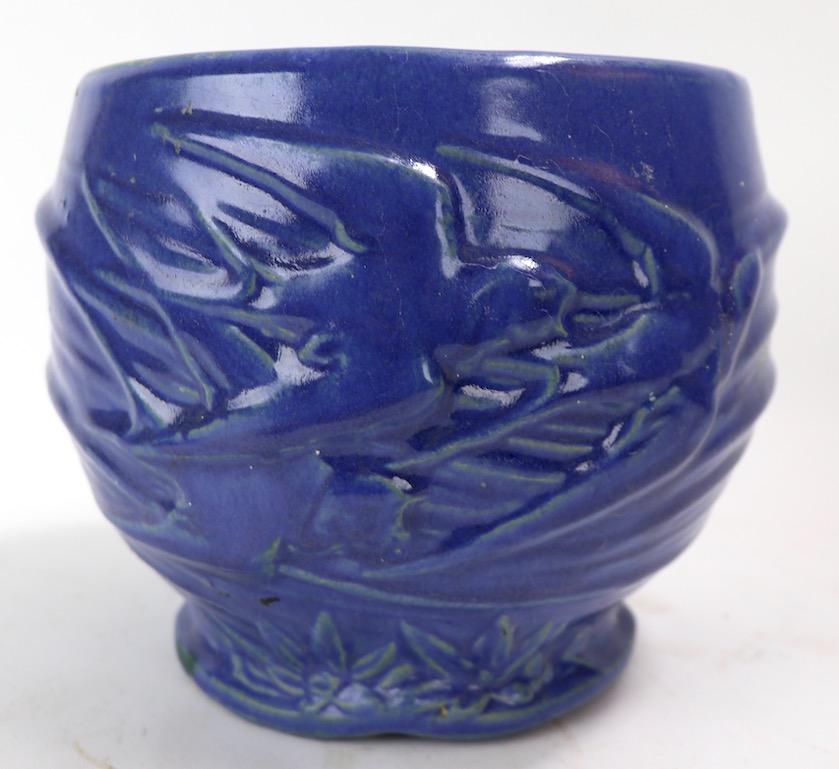 Interesting example of American Art Pottery from the Ohio School. This jardiniere wade by the McCoy Pottery Company, it has flying swallows ( Nelson McCoy pattern Flying Bird #22 Circa 1935 ) as the decorative motif, and is in an unusual blue glaze.