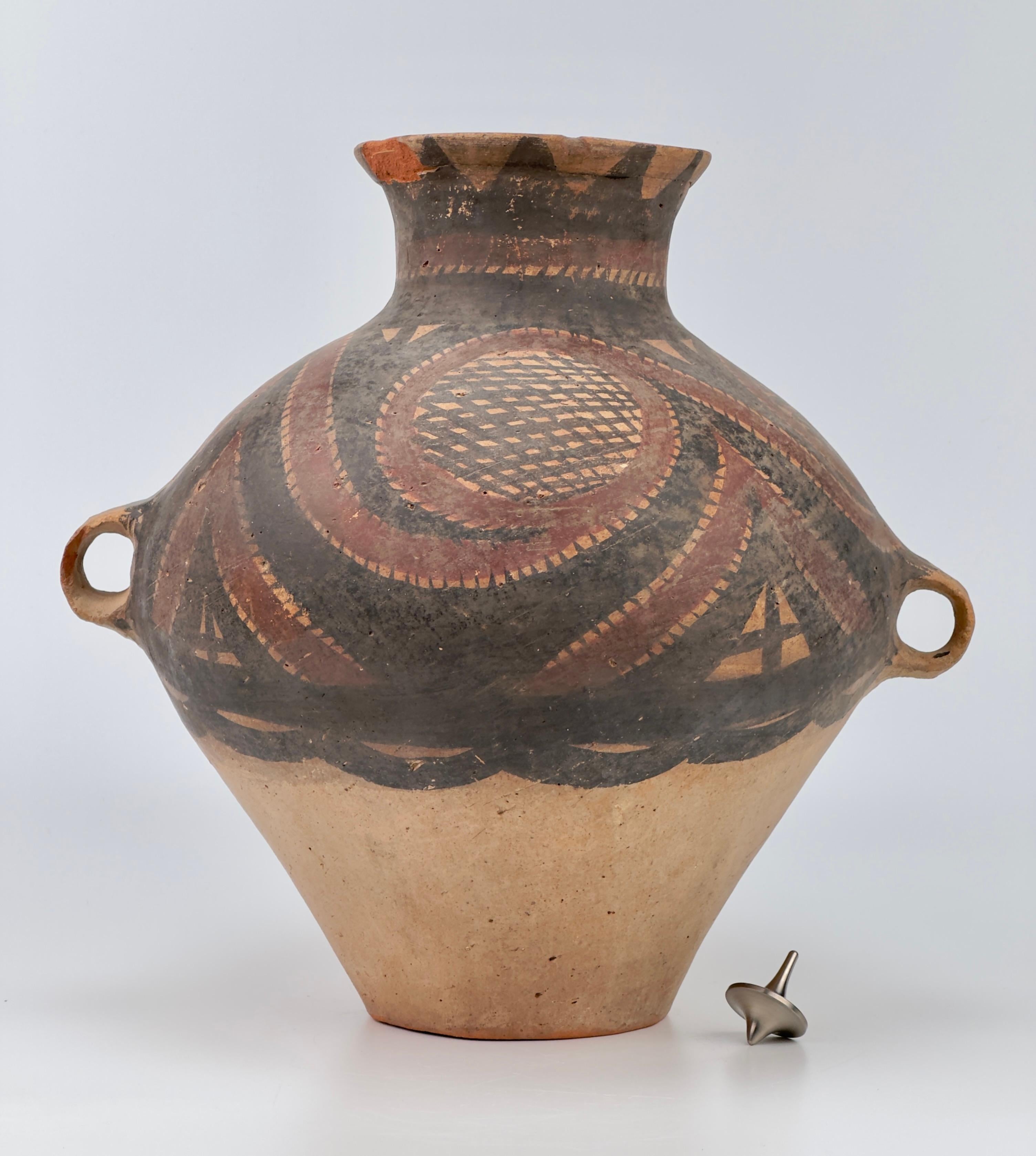 Large and small two-handled jars, pitchers, bowls, and beakers are the most common forms produced during the Machang phase of the Majiayao (or Gansu Yangshao) culture. The decorative motifs on Machang-period wares are primarily geometric, featuring