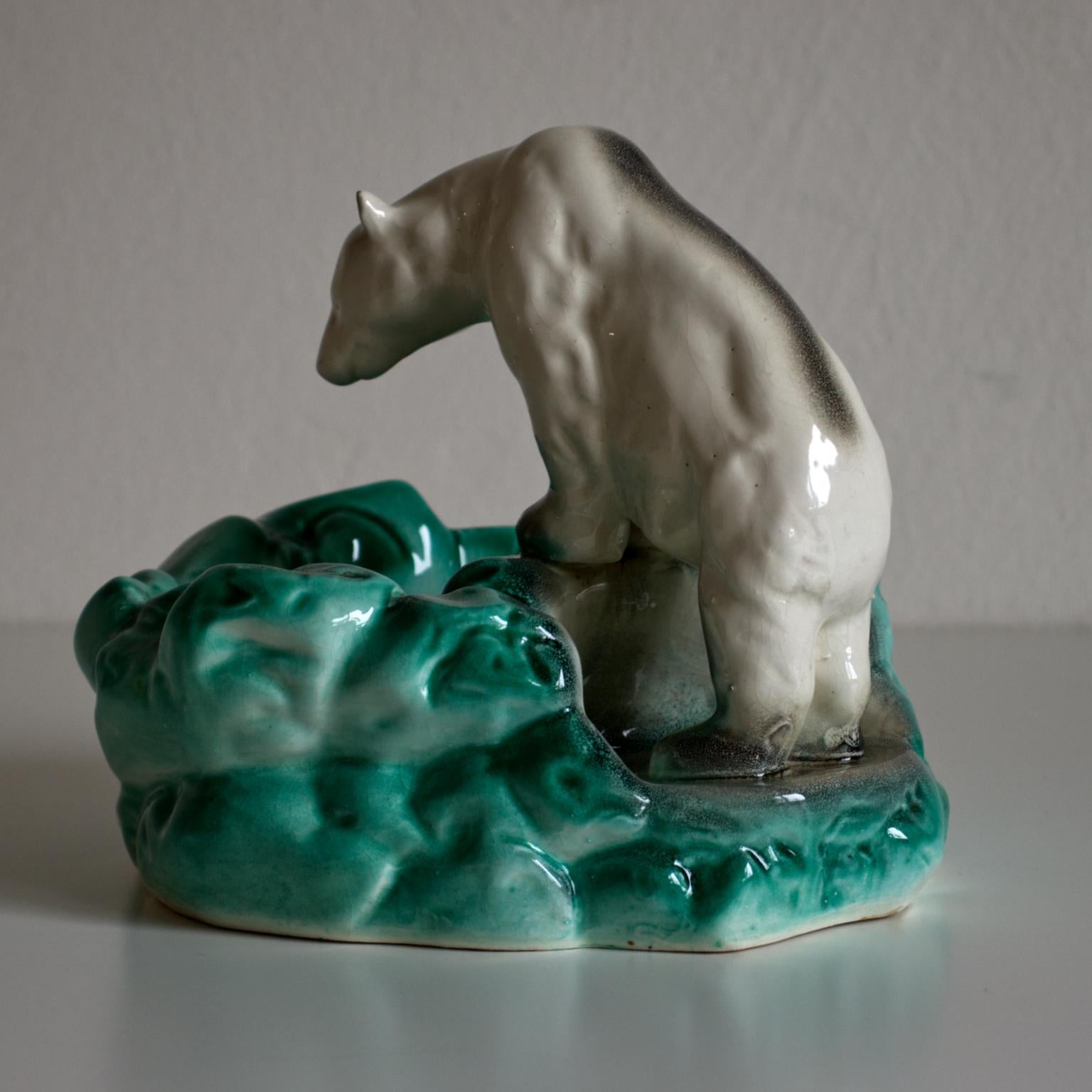 Polar bear at ice pool, a ceramic bowl manufactured by Jilove u Decína Pottery in Czechoslovakia in the 1930s. The bowl was designed to celebrate Nora, the first polar bear in the Prague Zoo in 1932. The piece is marked, Jilove u Decína Pottery made