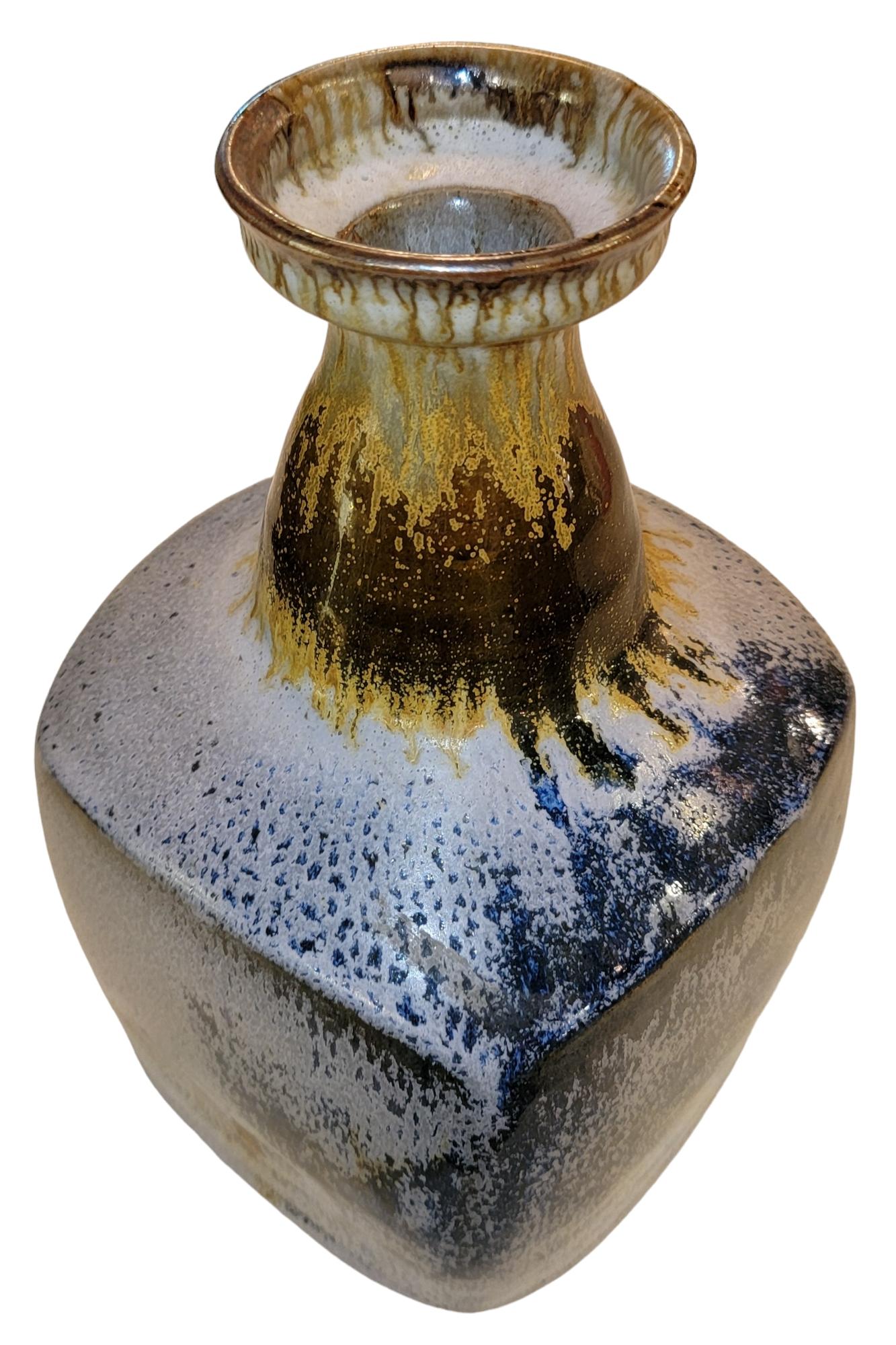 Pottery Vase With Drip Paint. Wonderful texture that is accentuated by the precise paint. There are many different tones flow thought the exterior leading the seer downward or upward at a glance.
Measures approx - 6.5w x 6.5d x 11.5h