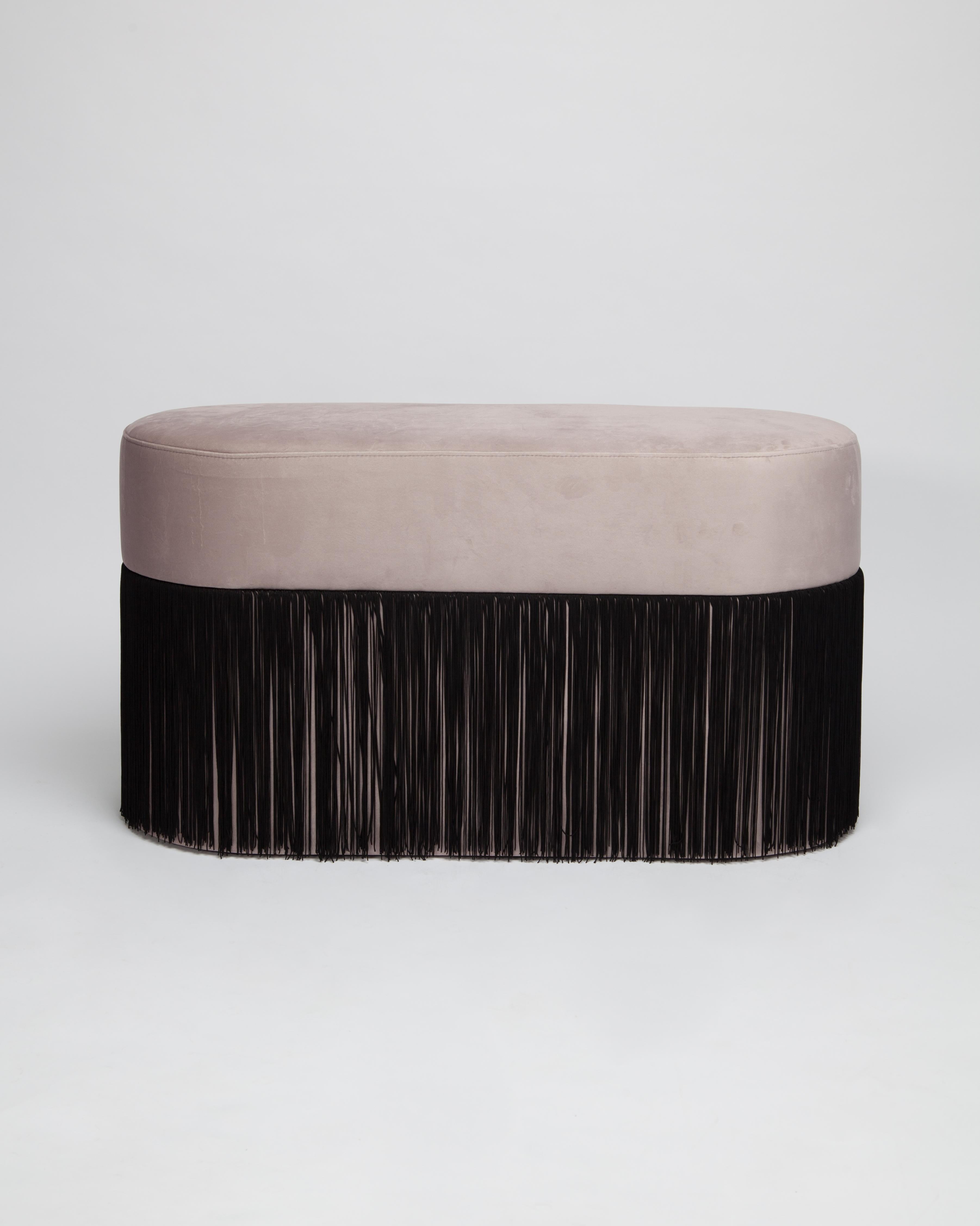 Pouf pill L by Houtique
Dimensions: H 45 x 80 x 35 cm
Materials: Velvet upholstery and 30cm fringes

Pill Pouf L
Art-deco style pouf with wood structure and velvet fabric.
2 fiber-board discs of 16mm, joined by wooden tufts.
Upholstery Velvet