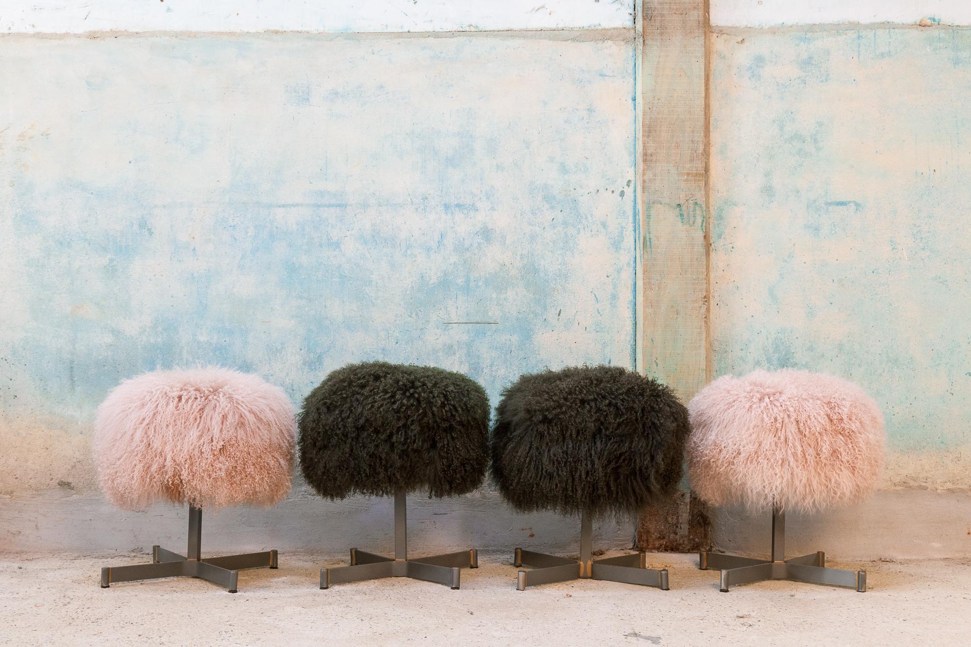 Those four adorable stools has been reupholstered by myself in my workshop in Bretagne-France

As a professional upholsterer, I chose a light pink and kaki green sheep skin to revive them. Skin are from the french 