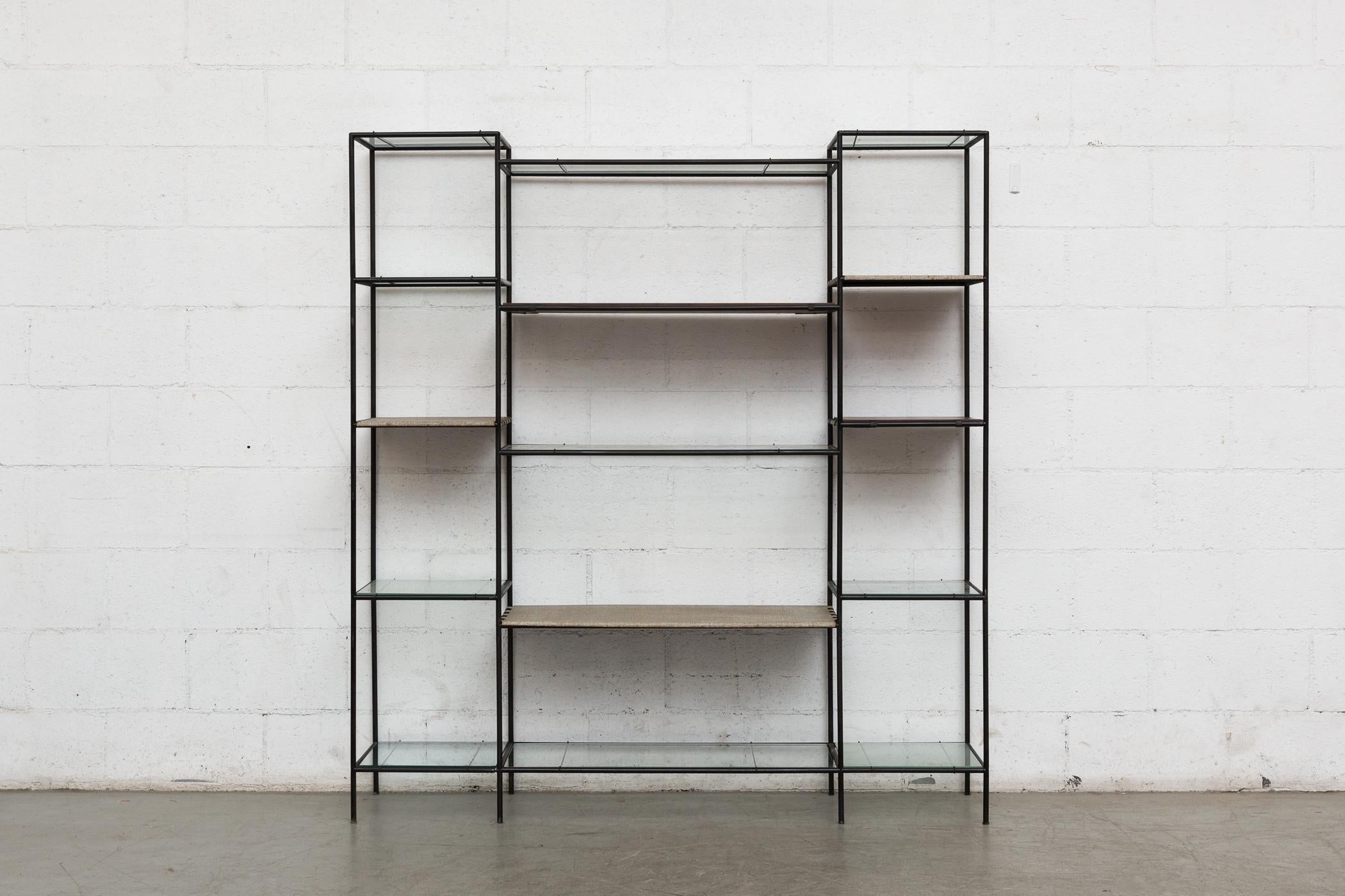 Cadovious abstracta standing wall unit or room divider. Black enameled metal frame. Re-arrangeable shelves in glass, teak and vinyl wrapped metal. All in original condition, visible wear consistent with its age and use.