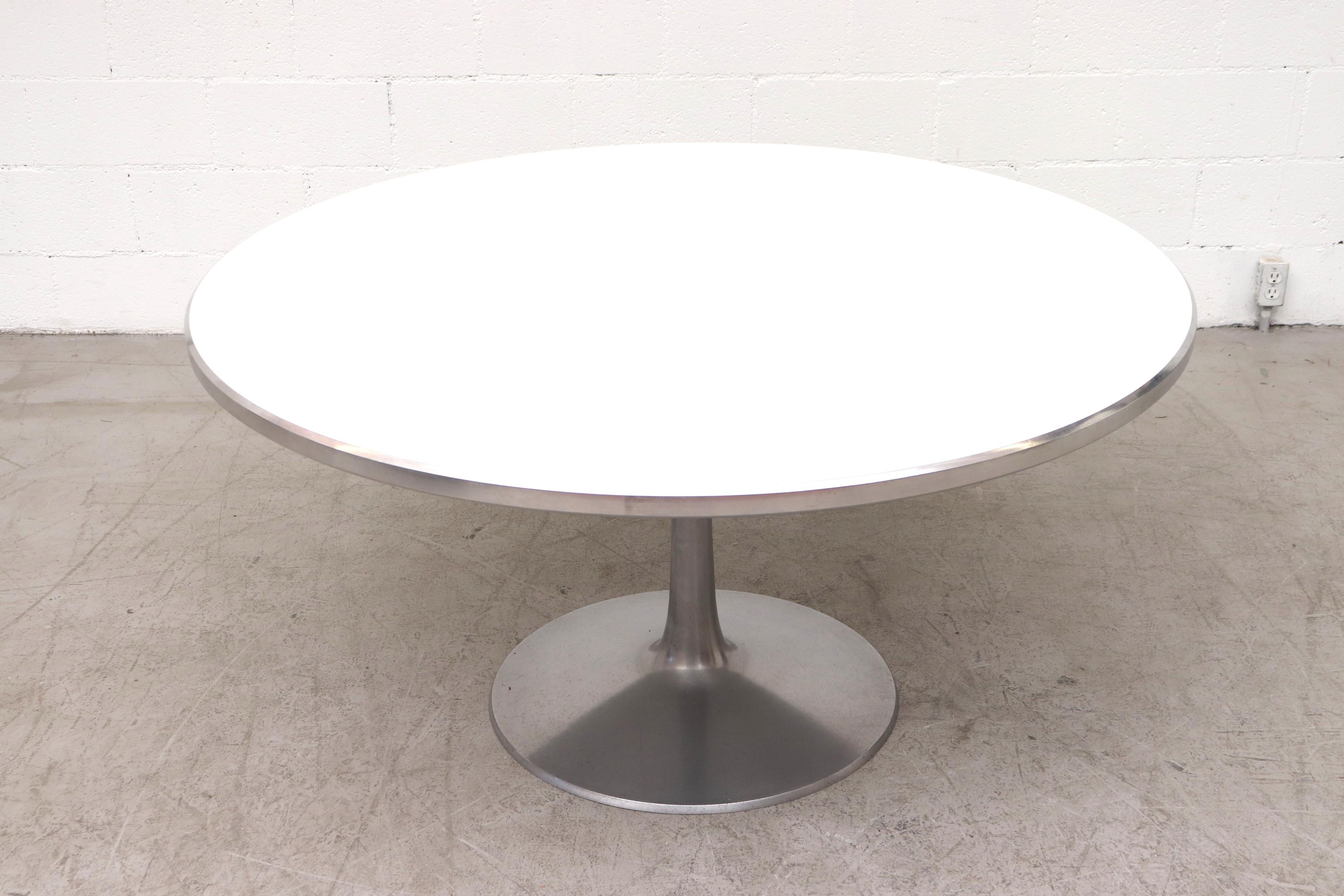Large Poul Cadovius round dining table with aluminum metal base and trim and white formica top. In original condition with moderate wear to base and top. Shot with Maison Jansen (attr) Chrome and suede dining chairs (SJA15). Another extra large