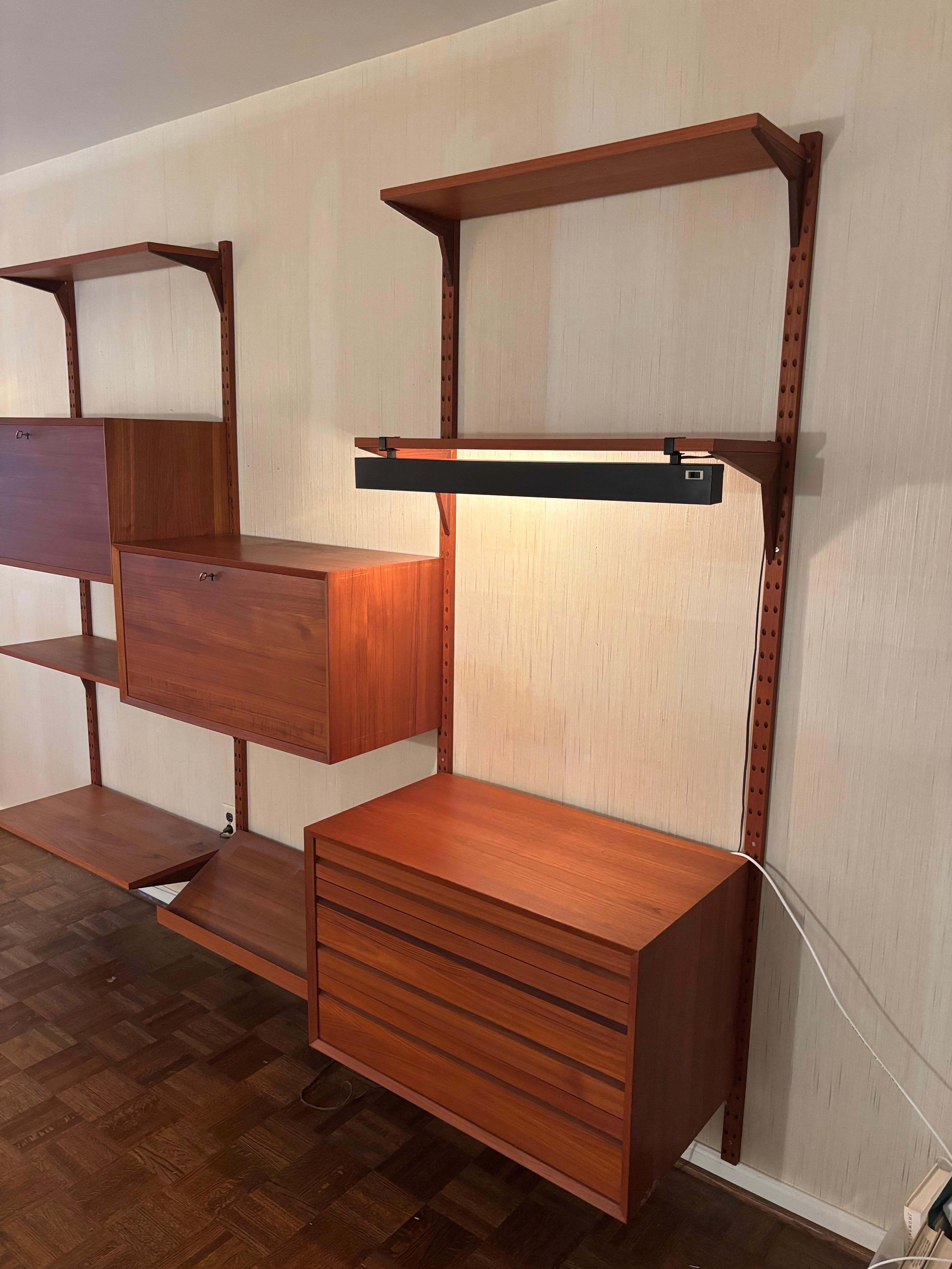 Poul Cadovius Cado Unit.  3 Bays make up this great unit!  Fully adjustable, Place Cabinets anywhere you like!  Cabinets include one Unit with drawers, one Cabinet with divides for records and one with mirrored back for a Bar and Liquor Cabinet. 