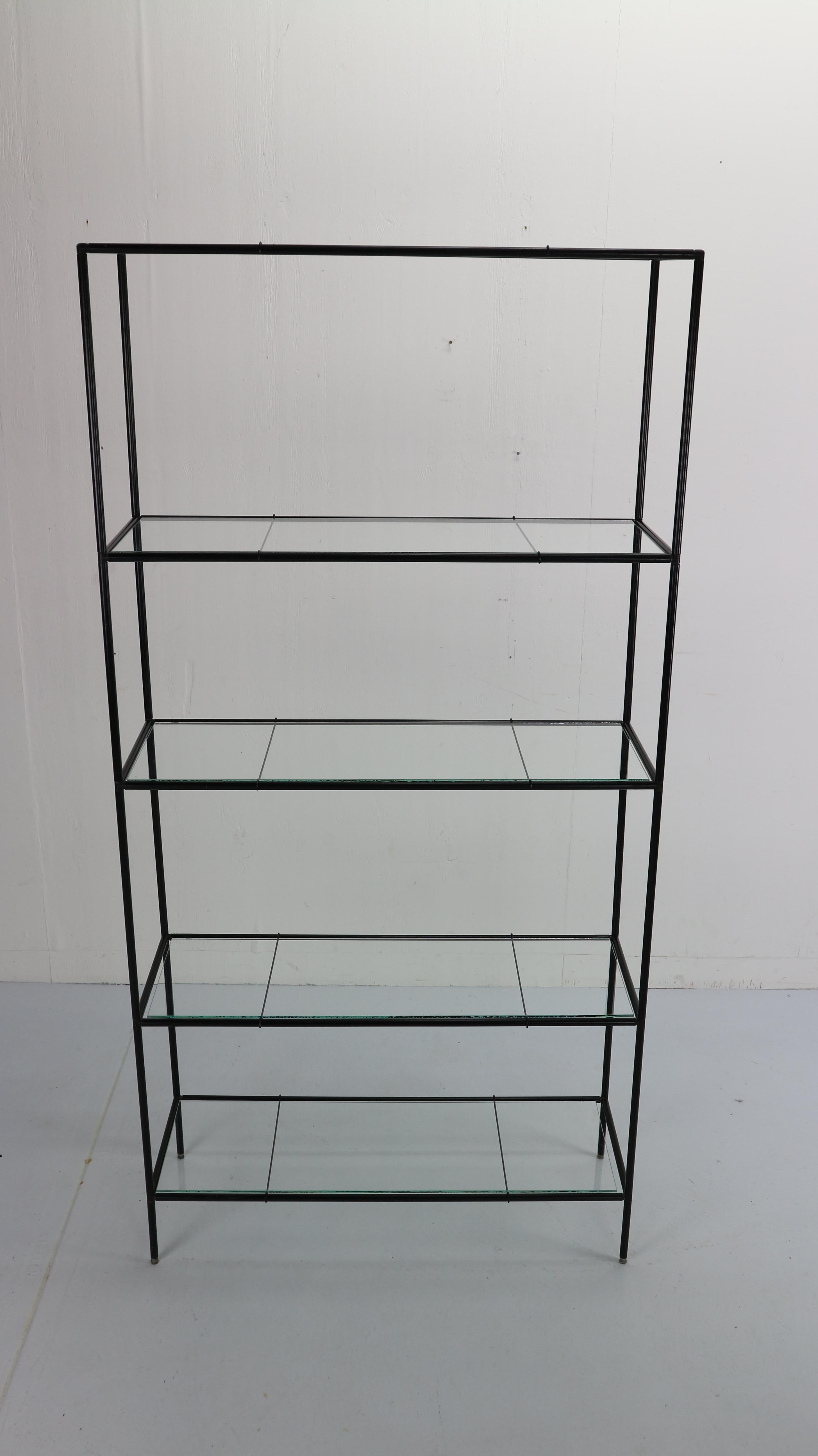Minimalist shelving unit designed by and produced by Royal System, Denmark, circa 1960. This modular system exists of black metal tubes with connectors, floating glass shelves. 
We have more of abstracta shelving units see our other listings.